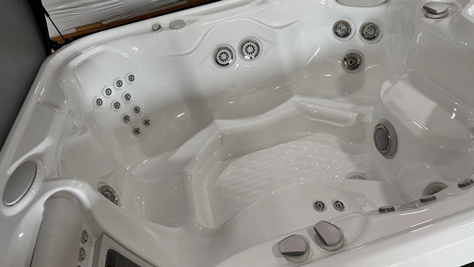 White luxury hot tub interior with multiple adjustable water jets and ergonomic seating areas for relaxation.