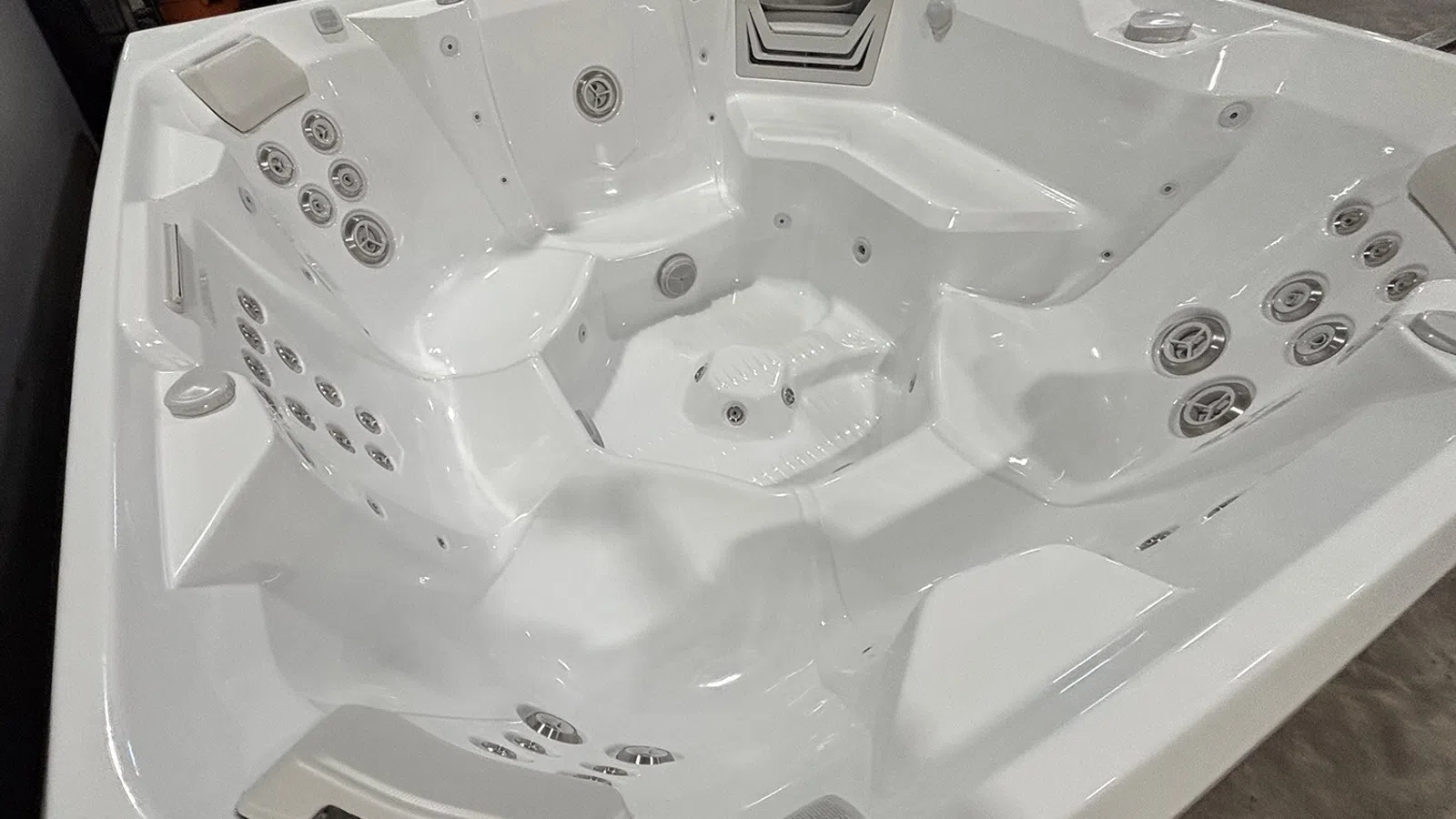 White multi-seat hot tub with multiple jets and contoured seats for hydrotherapy and relaxation