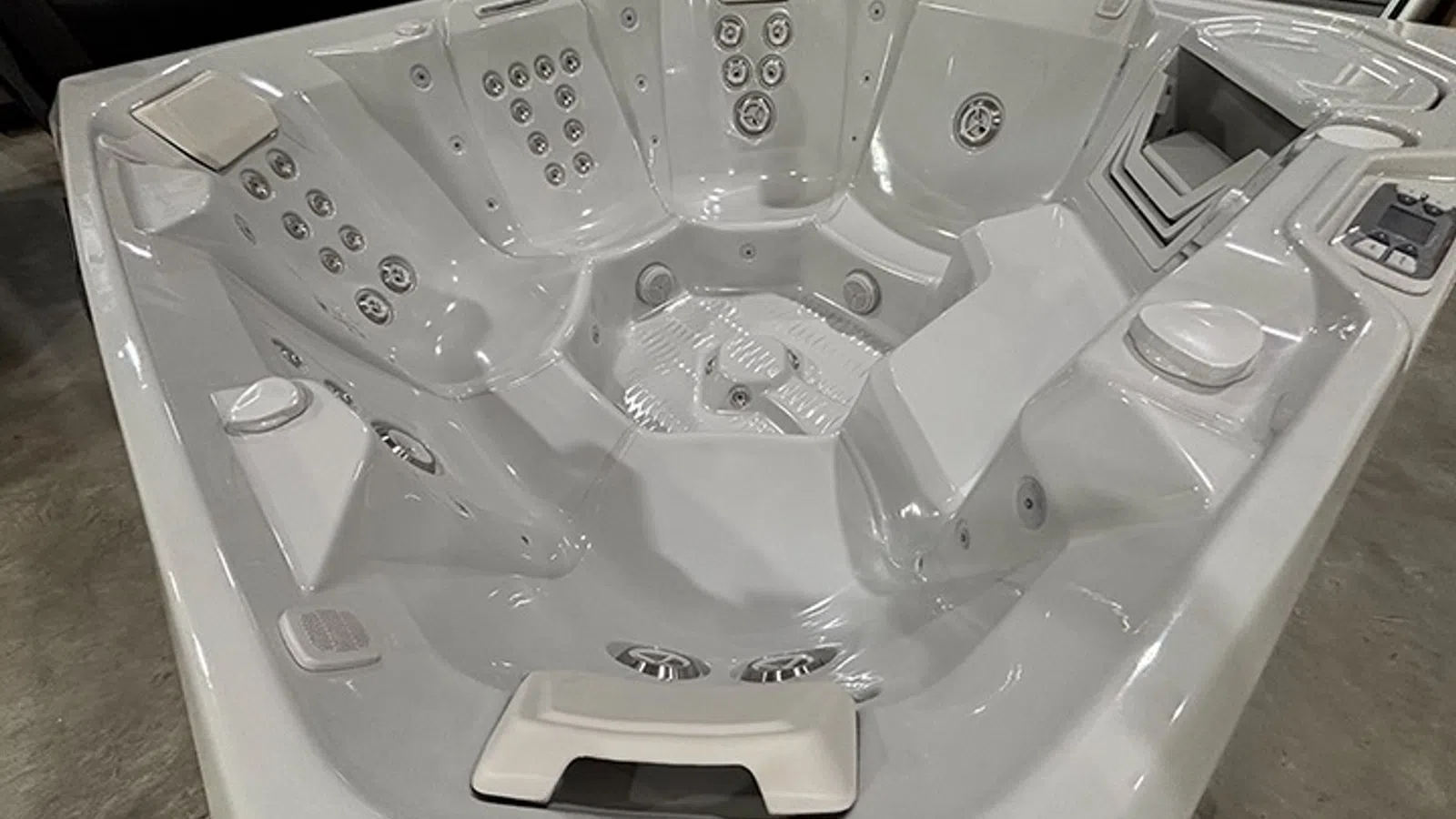 Modern white hot tub with multiple jets and ergonomic seating designed for relaxation and hydrotherapy.