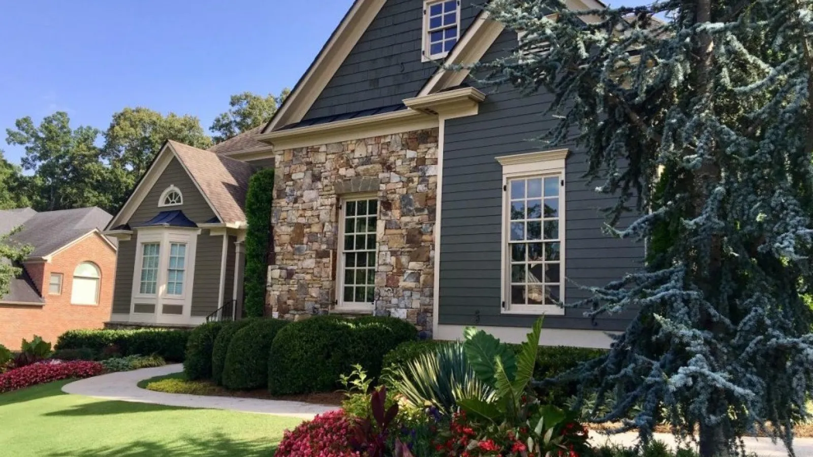 a house with many plants in the front yard