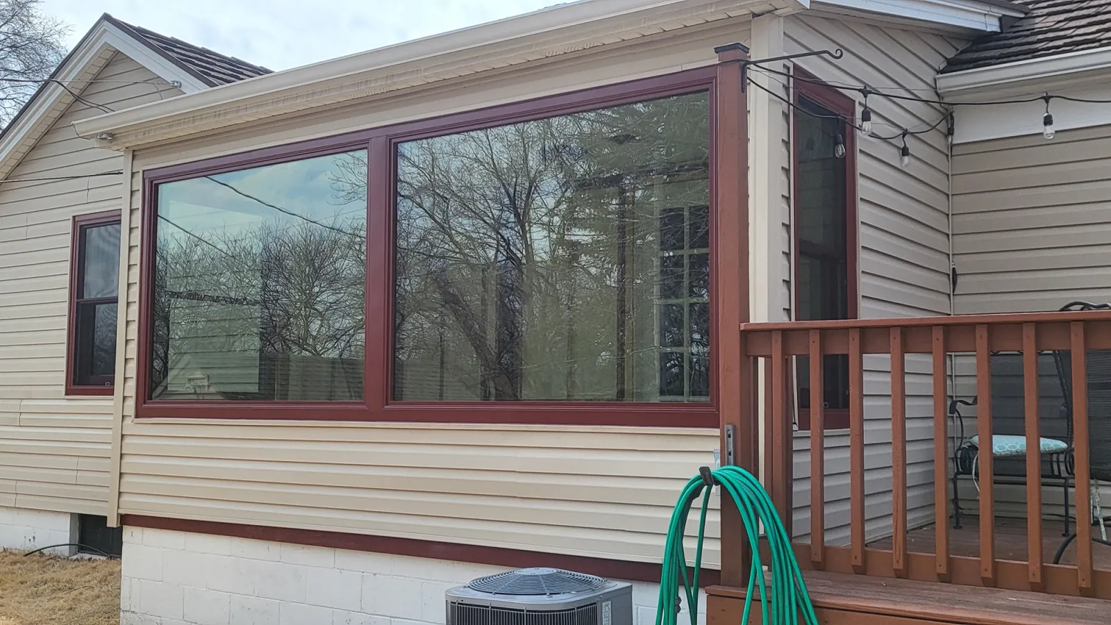 a house with a deck and a wood fence