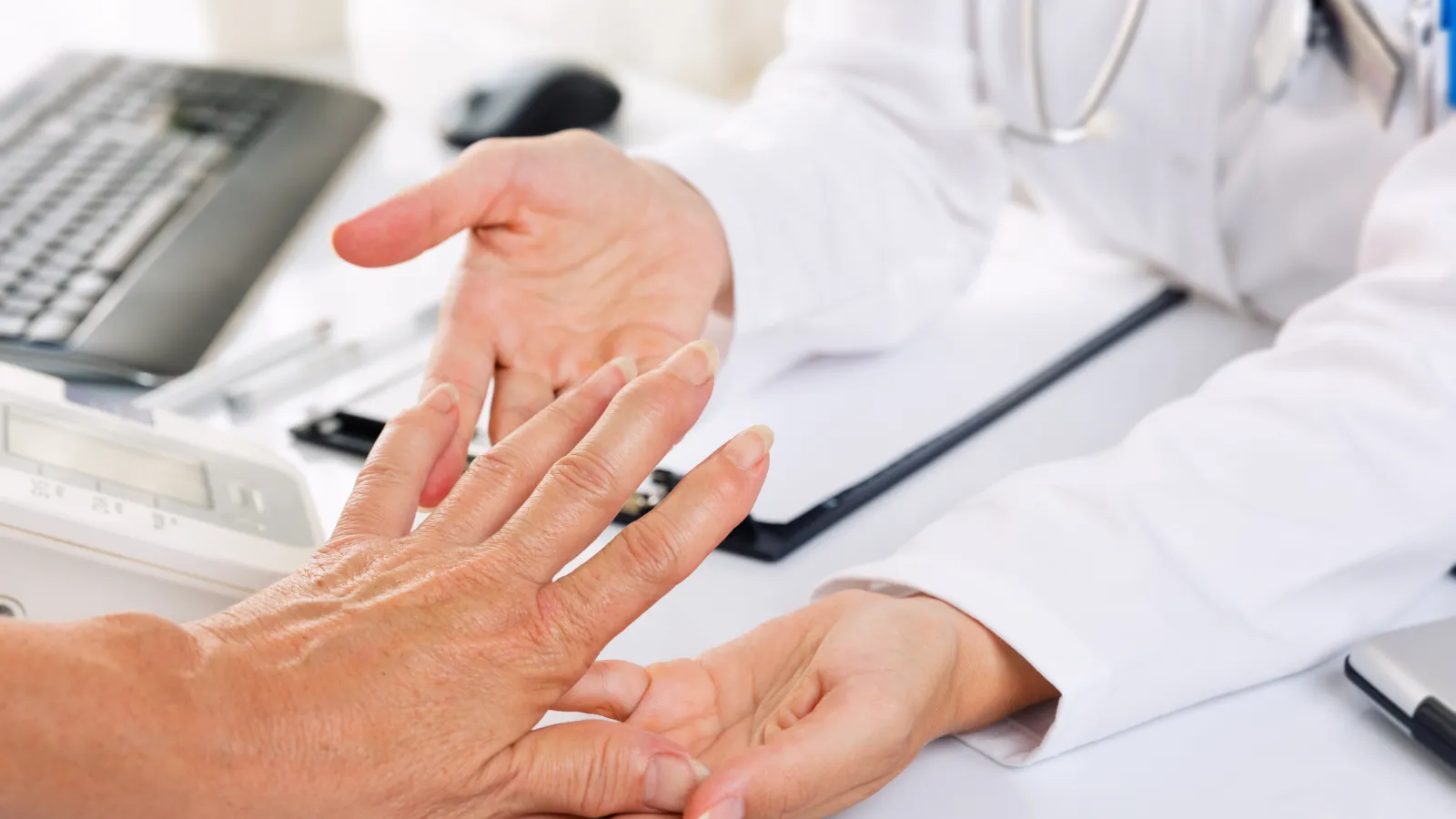 a close-up of a doctor holding a hand