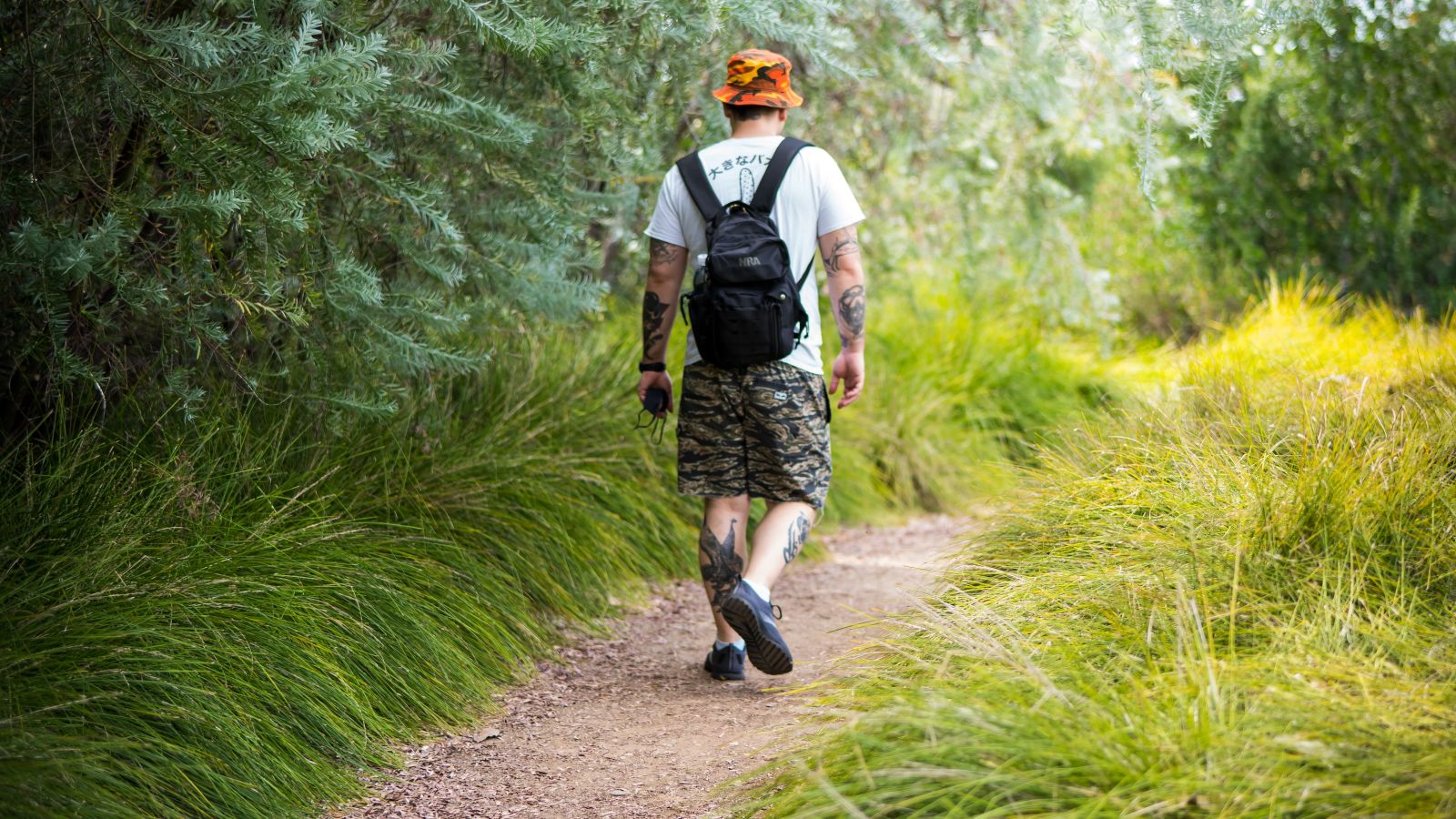 a man walking on a dirt path
