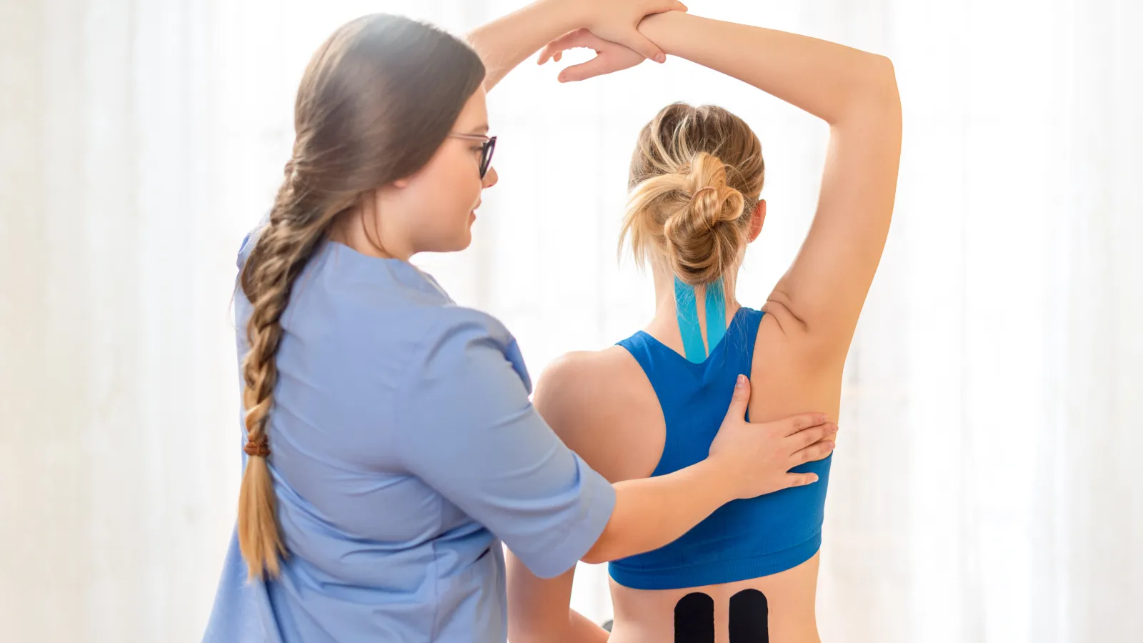 a woman with her hand on another woman's head