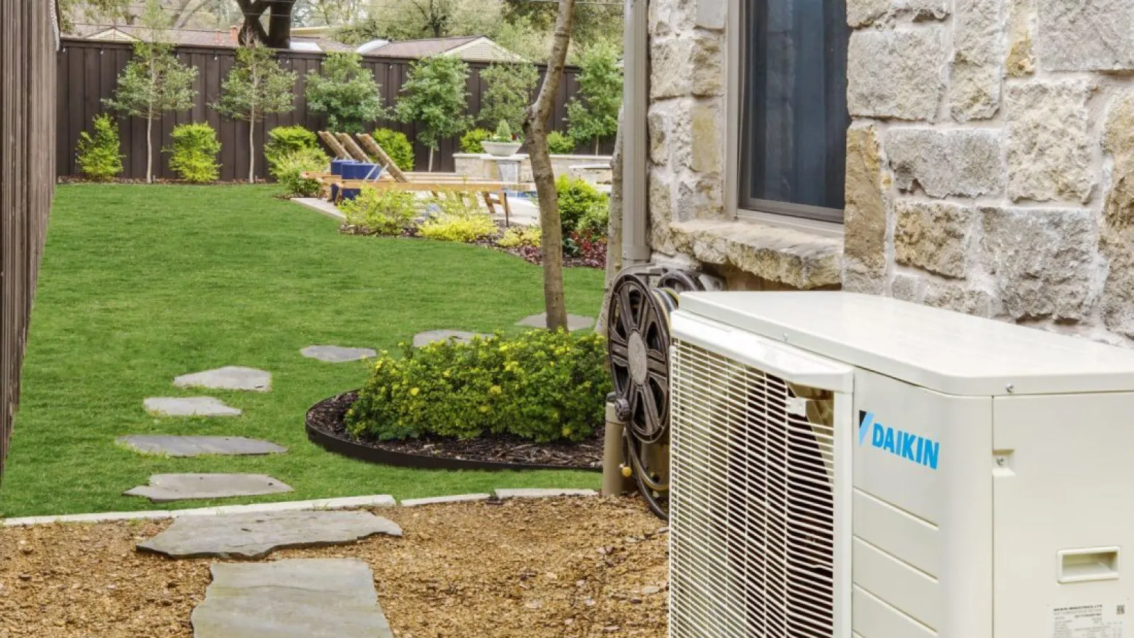 a small backyard with a daikin fit heating and air system