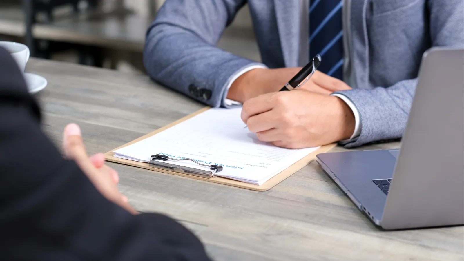 a person writing on a piece of paper