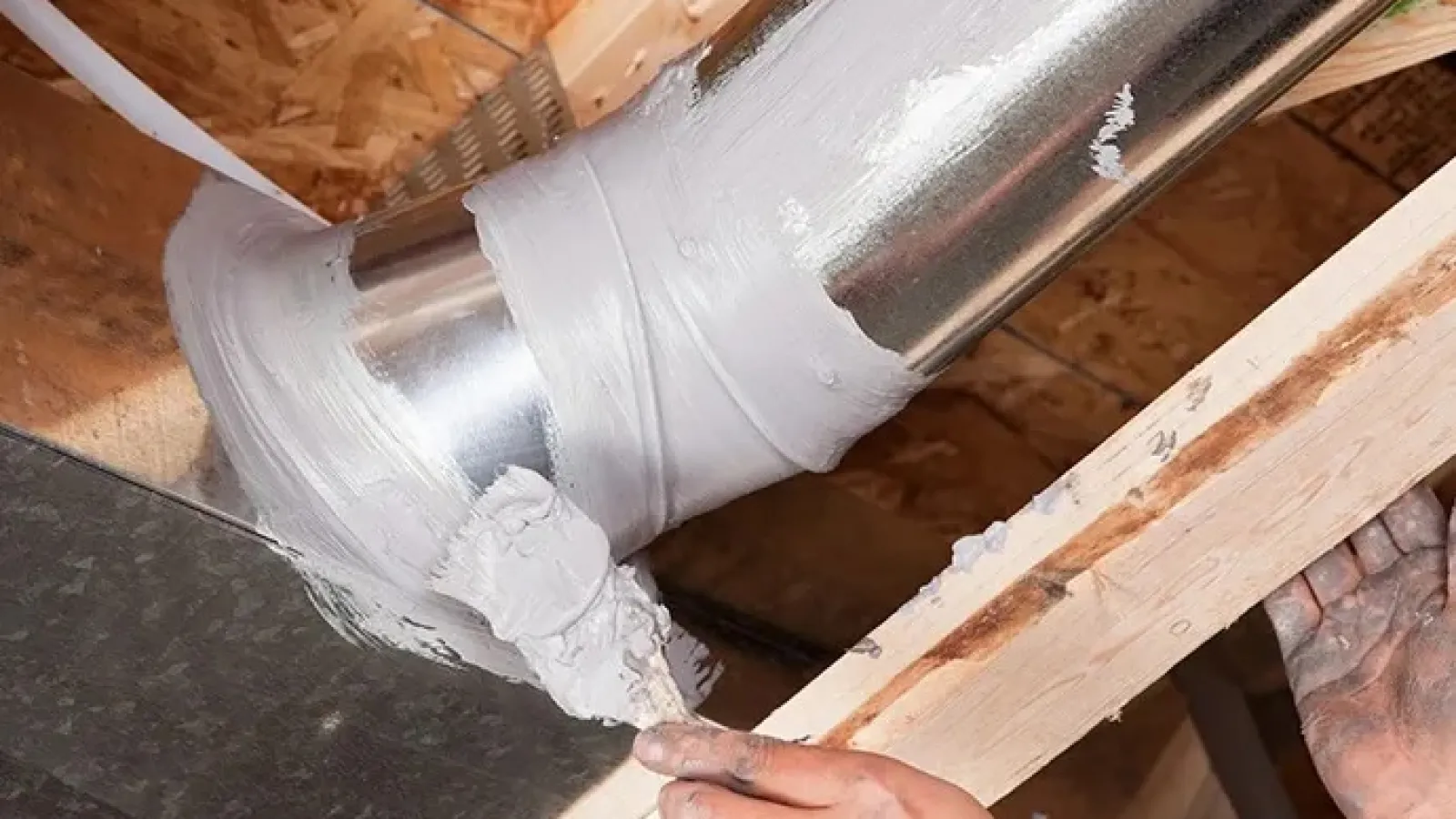 a person sealing home ductwork with mastic