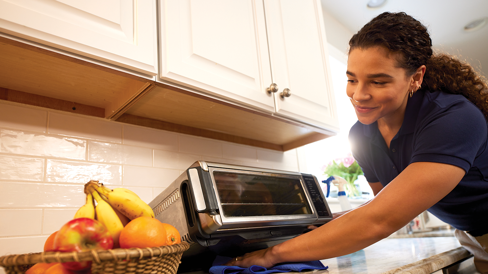 a person sitting on a kitchen counter