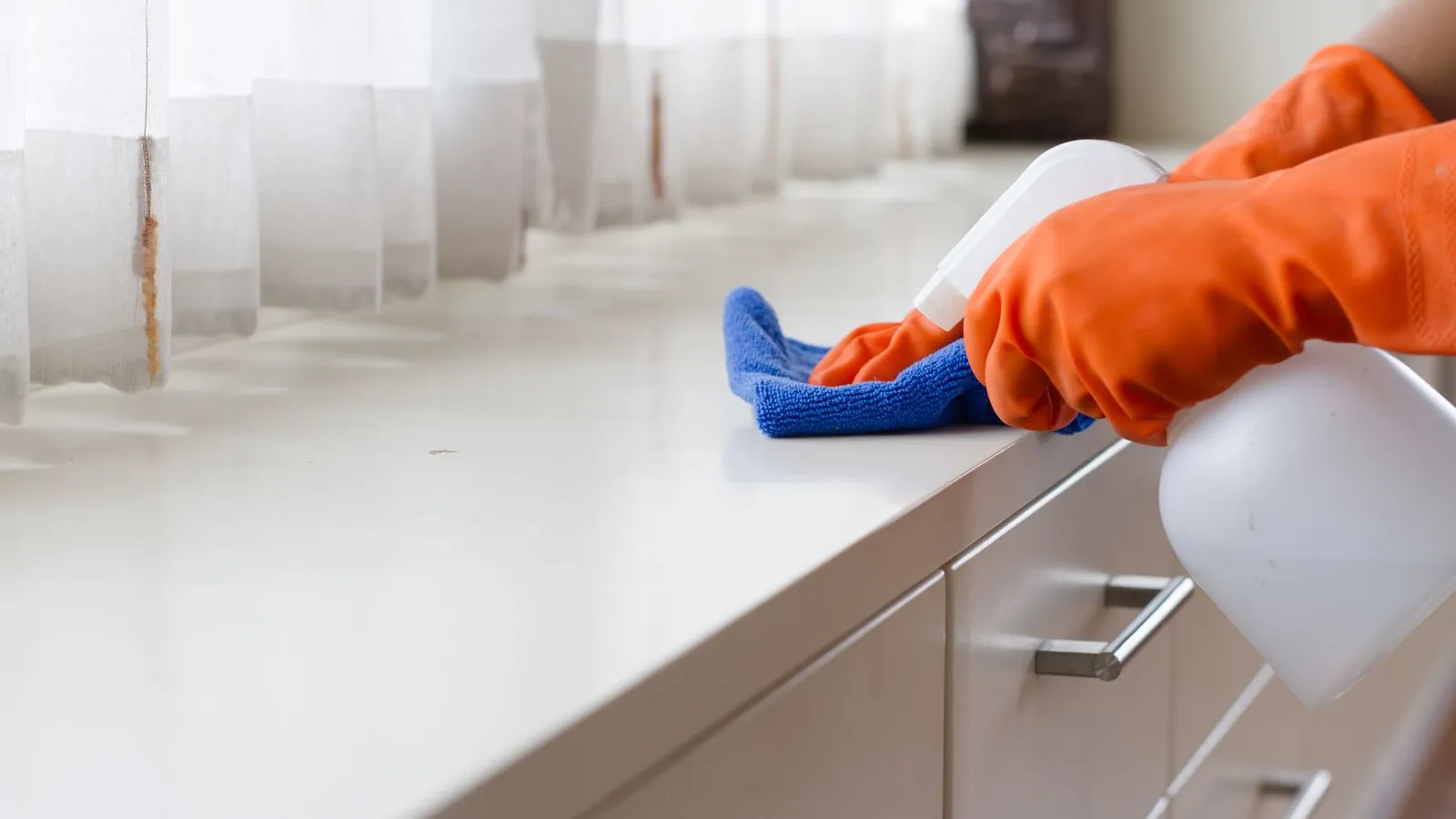 a person in a blue and orange garment on a white counter