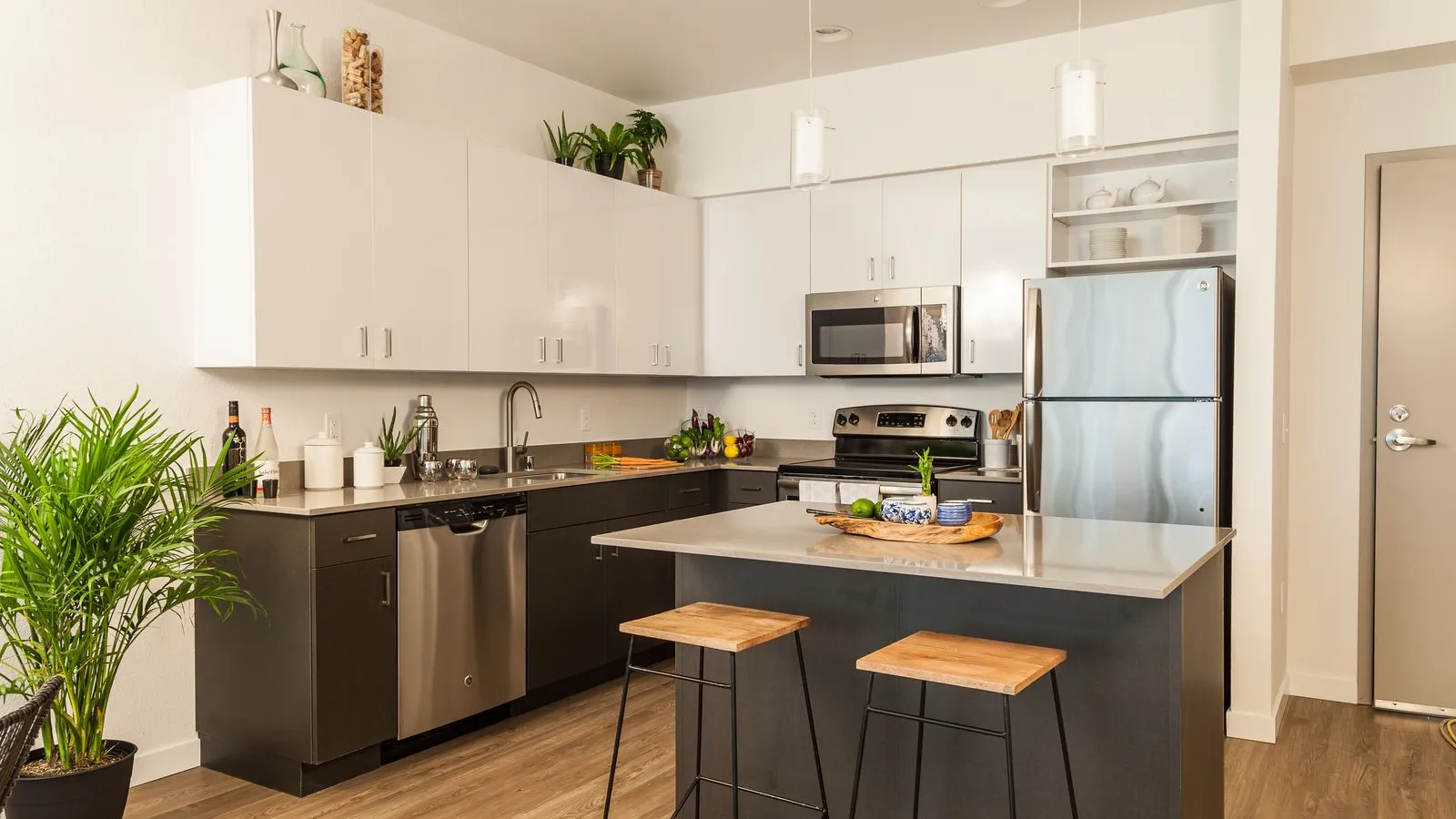 a kitchen with black counter tops