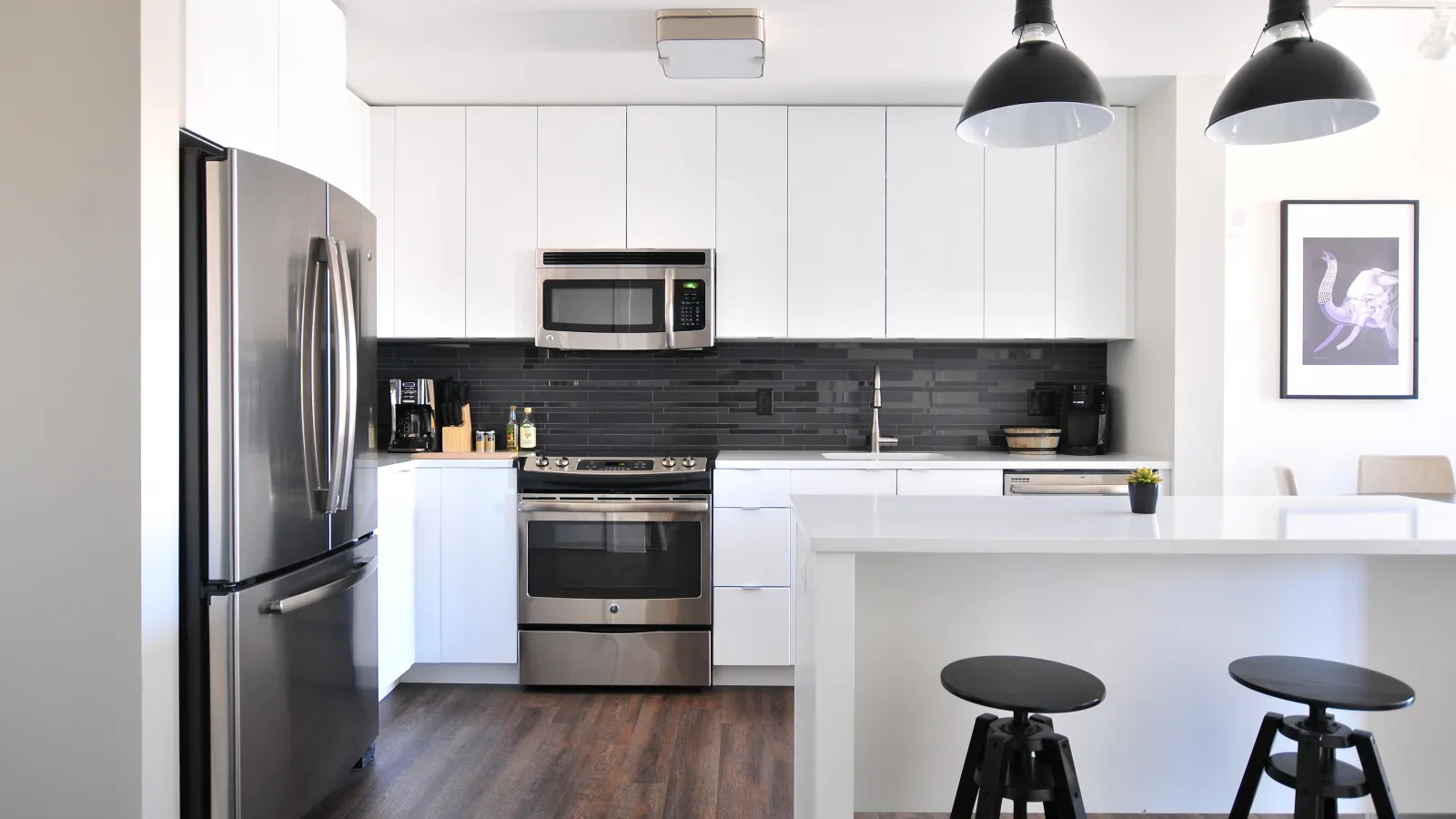 a kitchen with a bar stool and a refrigerator