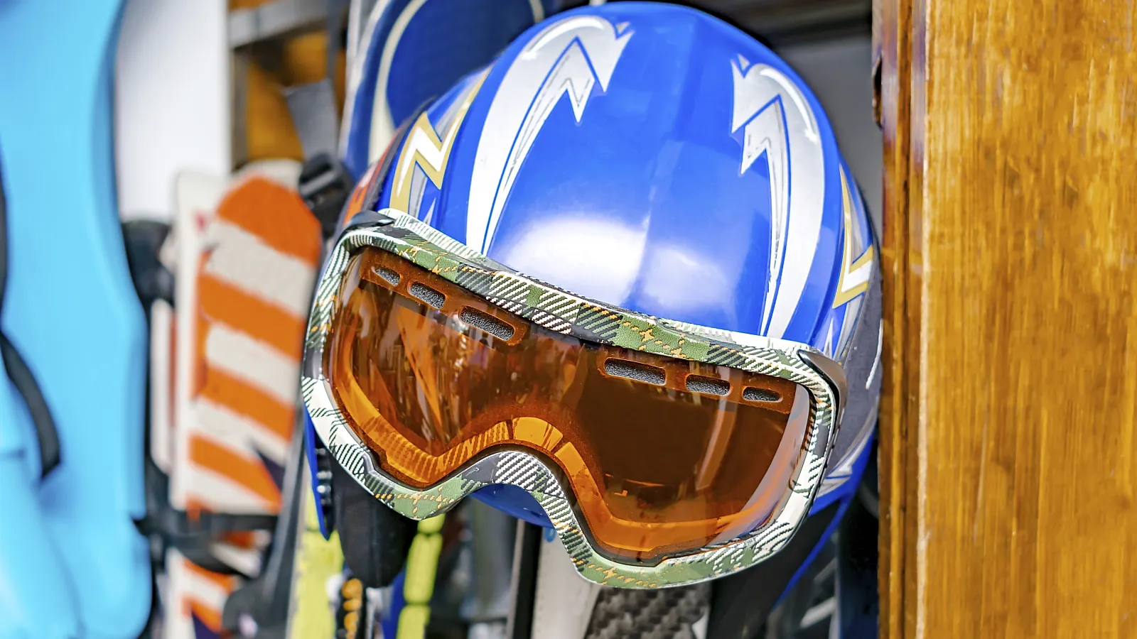 a ski helmet and snowboards in storage