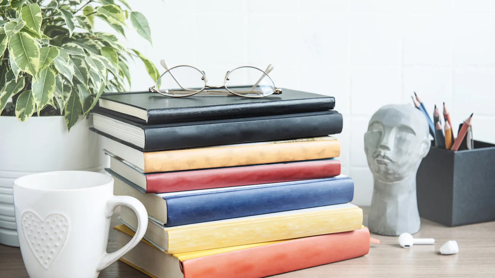 a stack of books and a mug