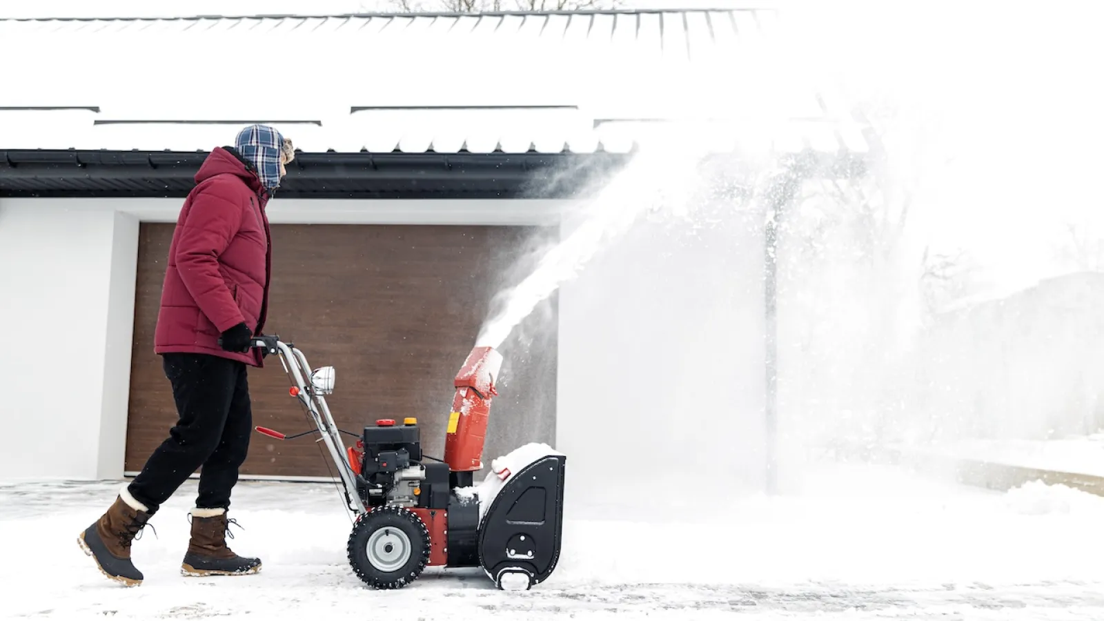 a man using a snow blower