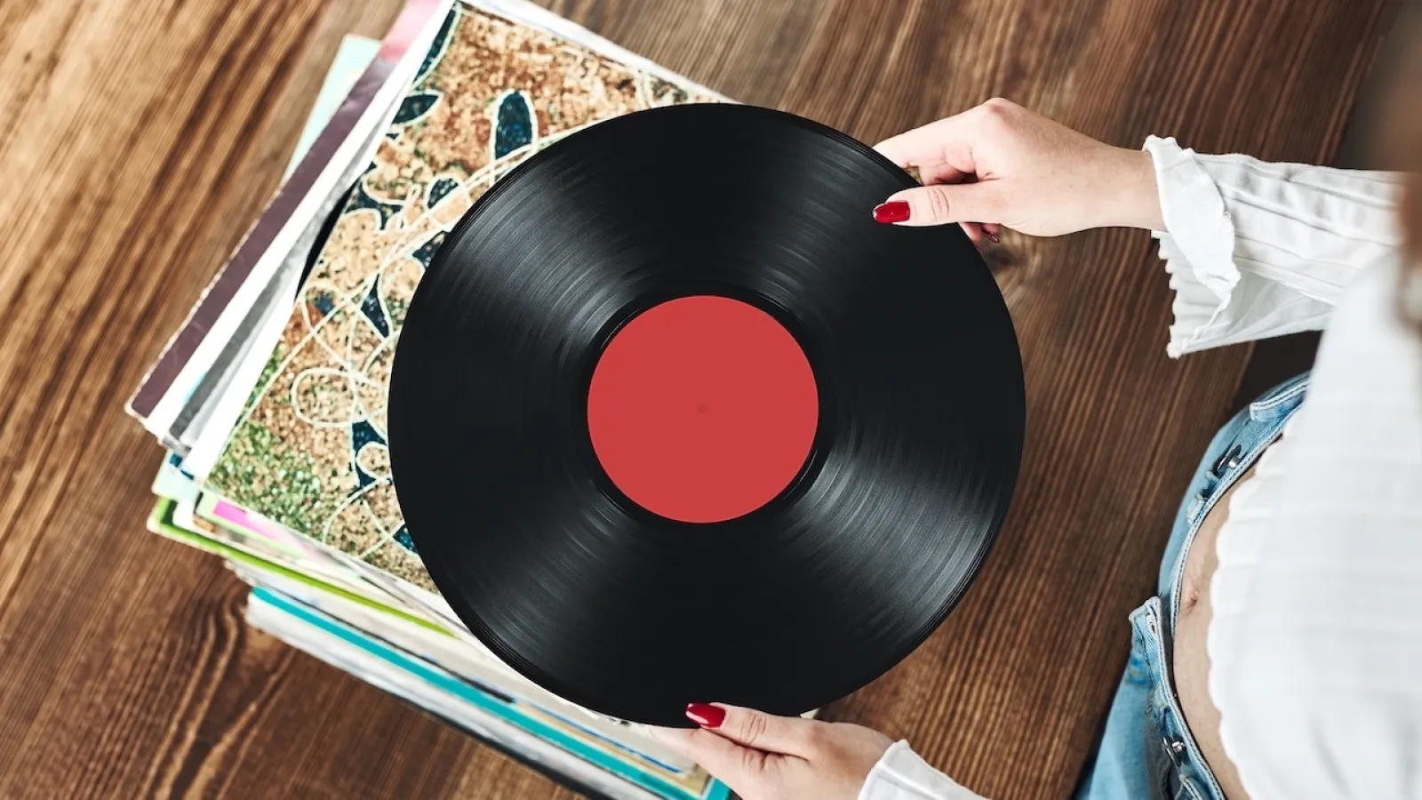 a person preparing a vinyl record for storage