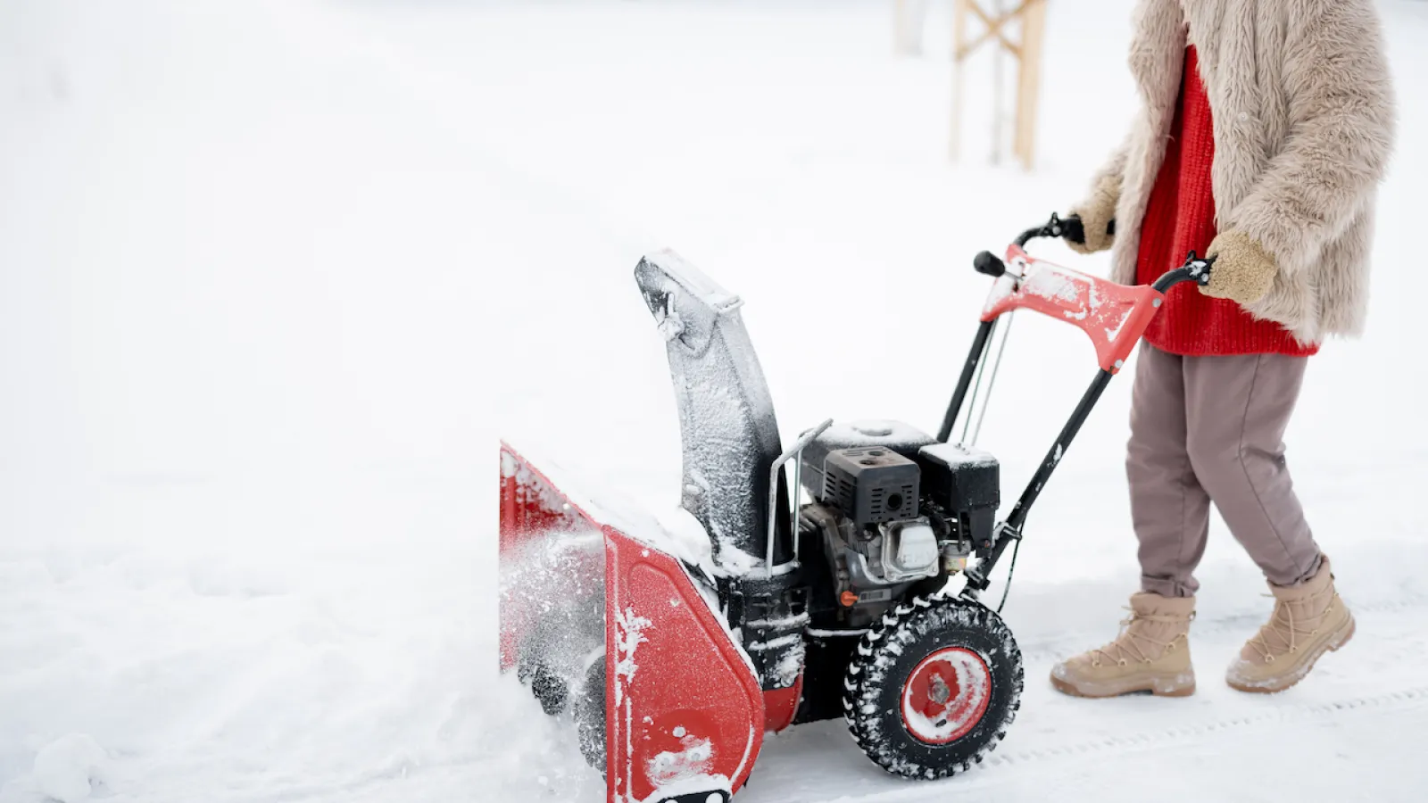 homeowner using snow blower machine