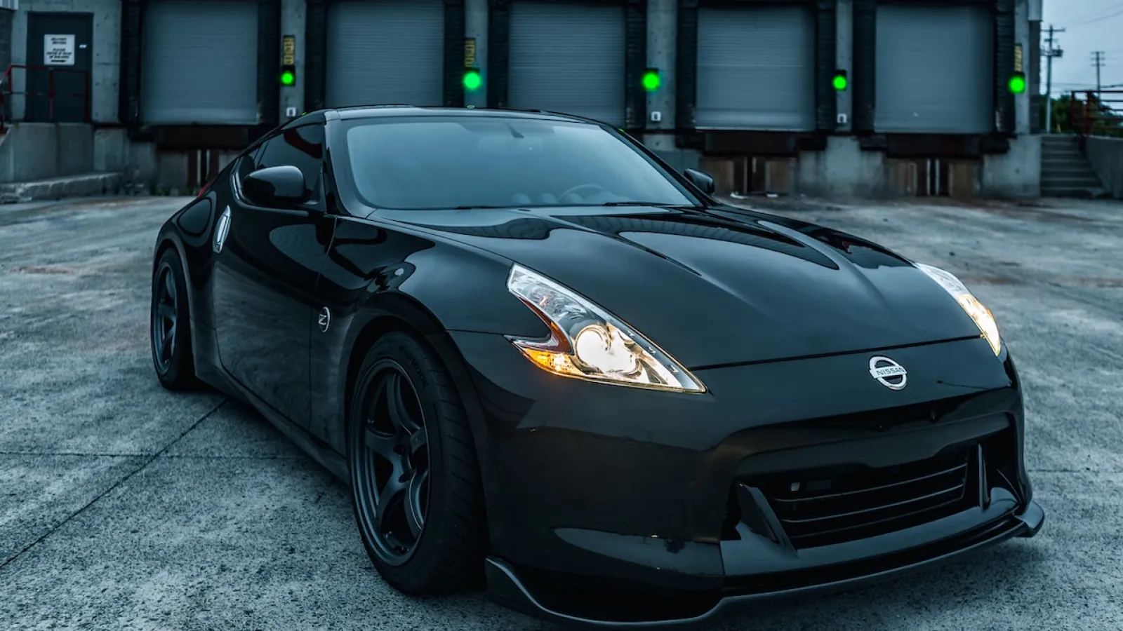 a black car parked in front of drive up storage