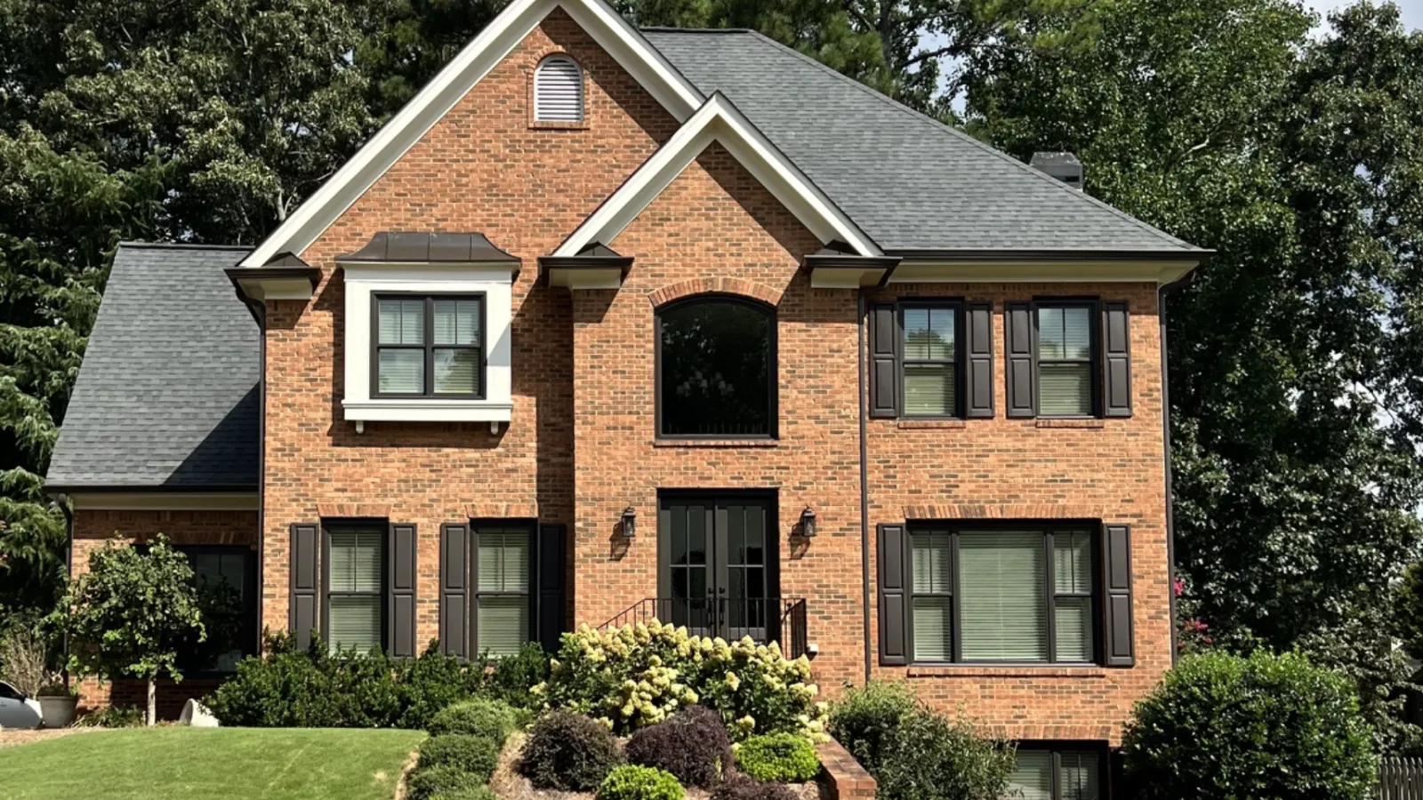 a brick house with a lawn in front of it