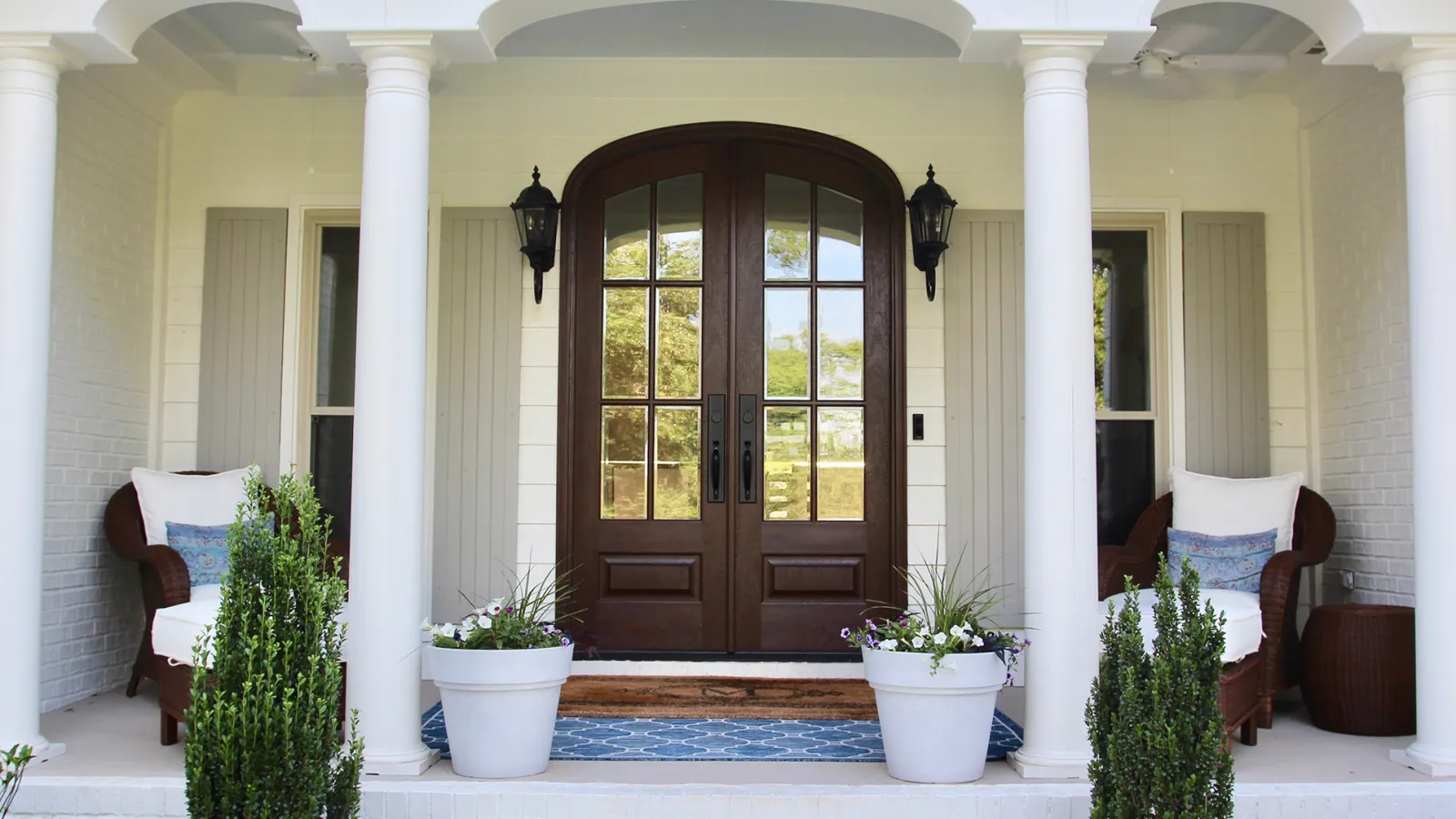 a house with a large door and white pillars