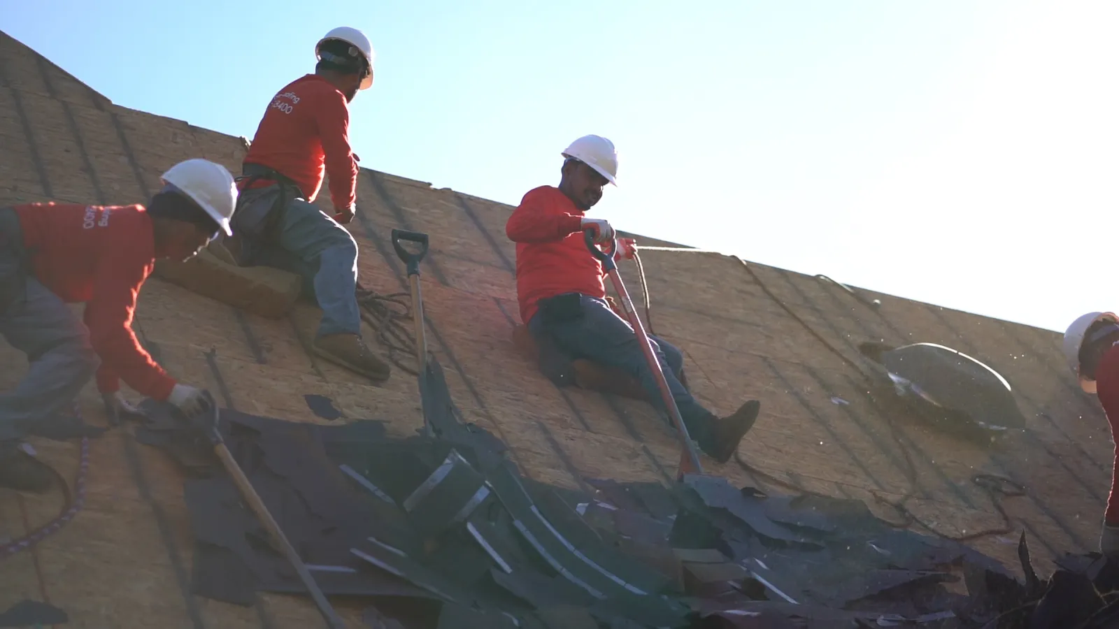 a group of men wearing hardhats and working on a construction site