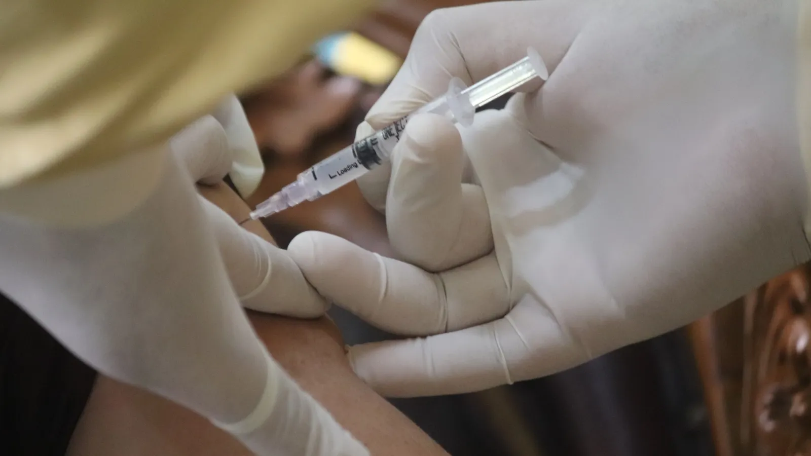 a person giving a shot