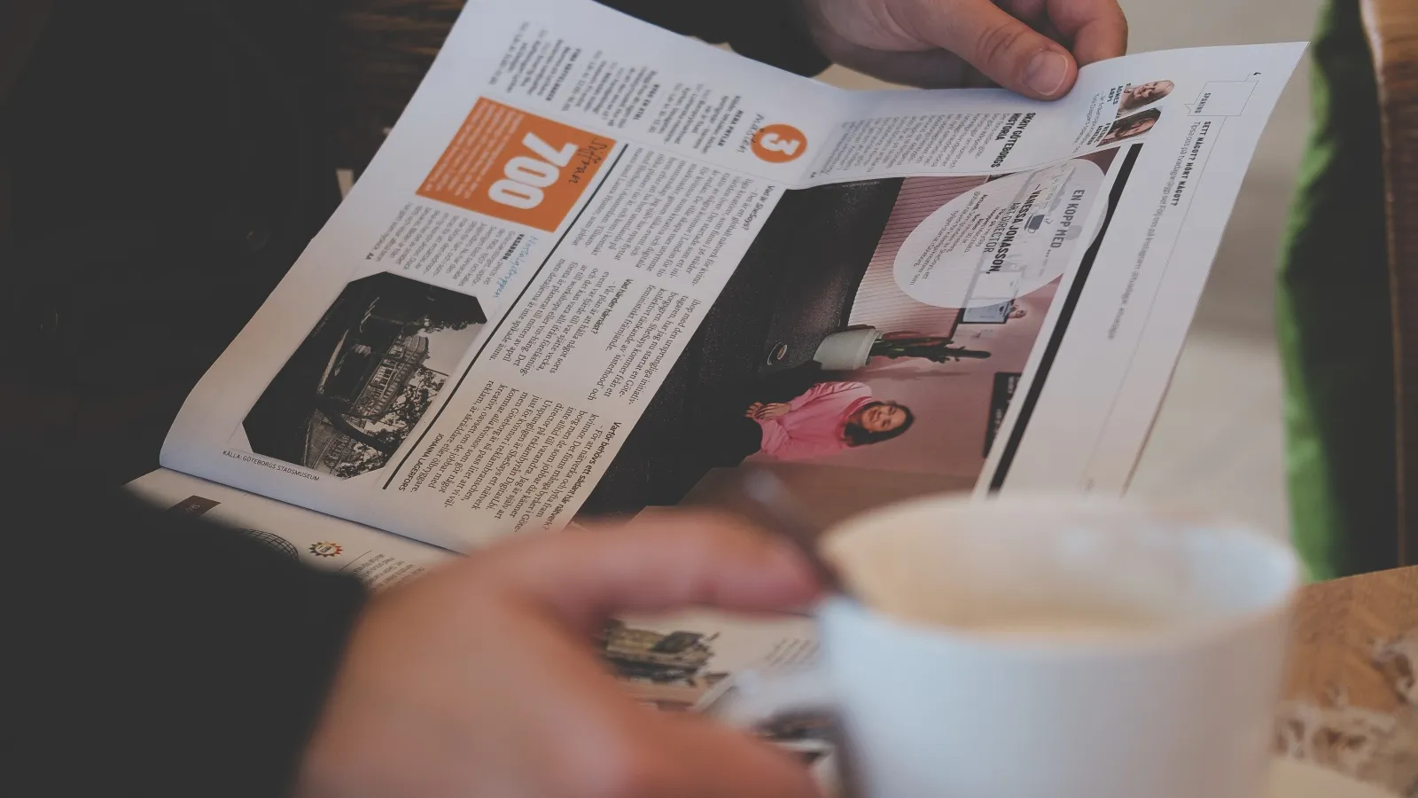 a person sitting at a table with a cup of coffee