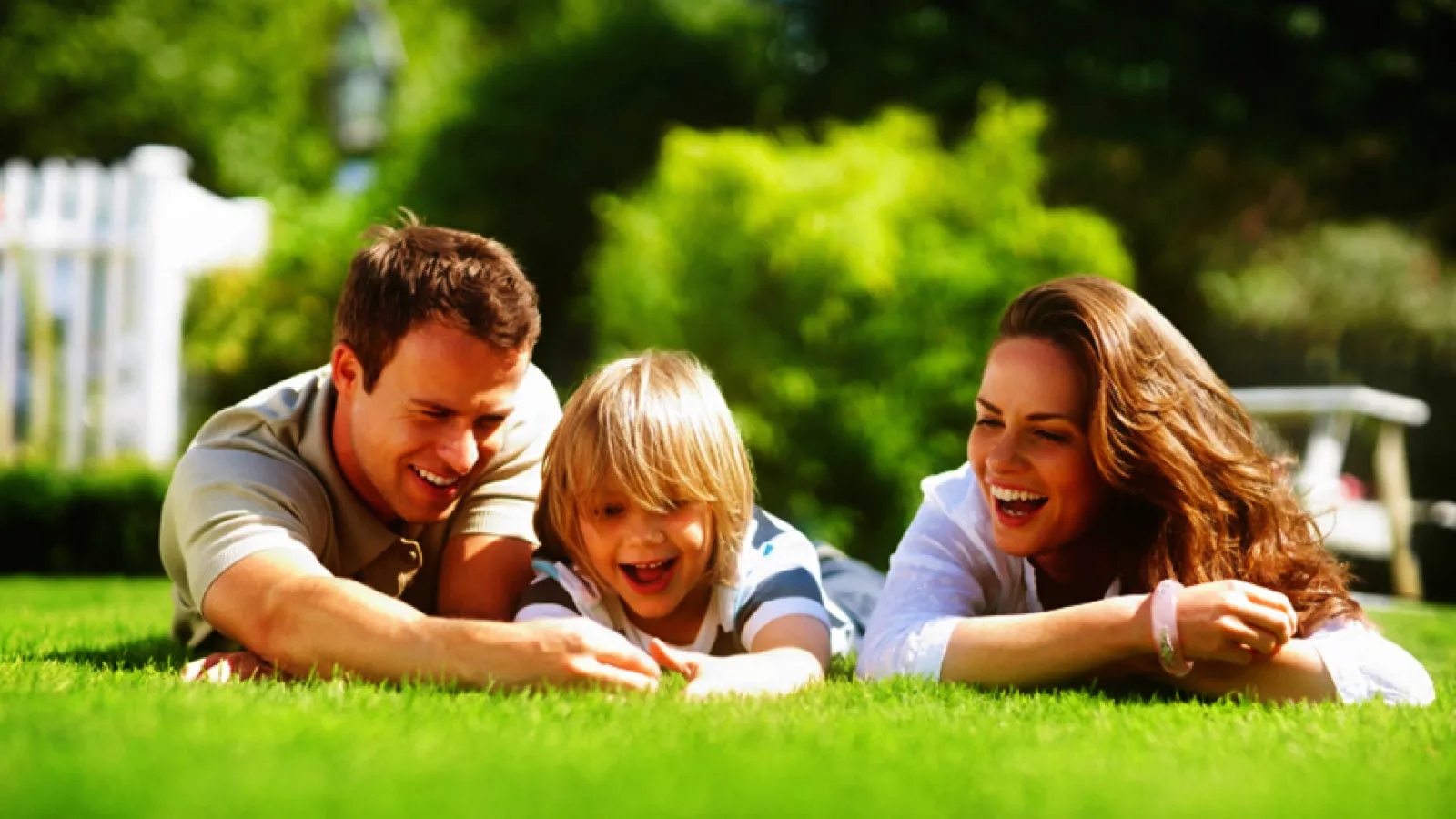 family lying in grass