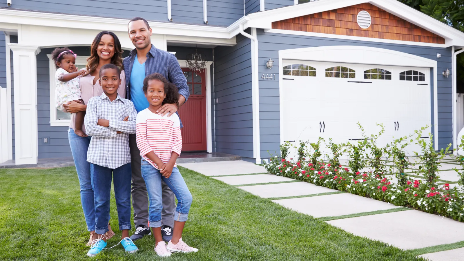 family in front of home