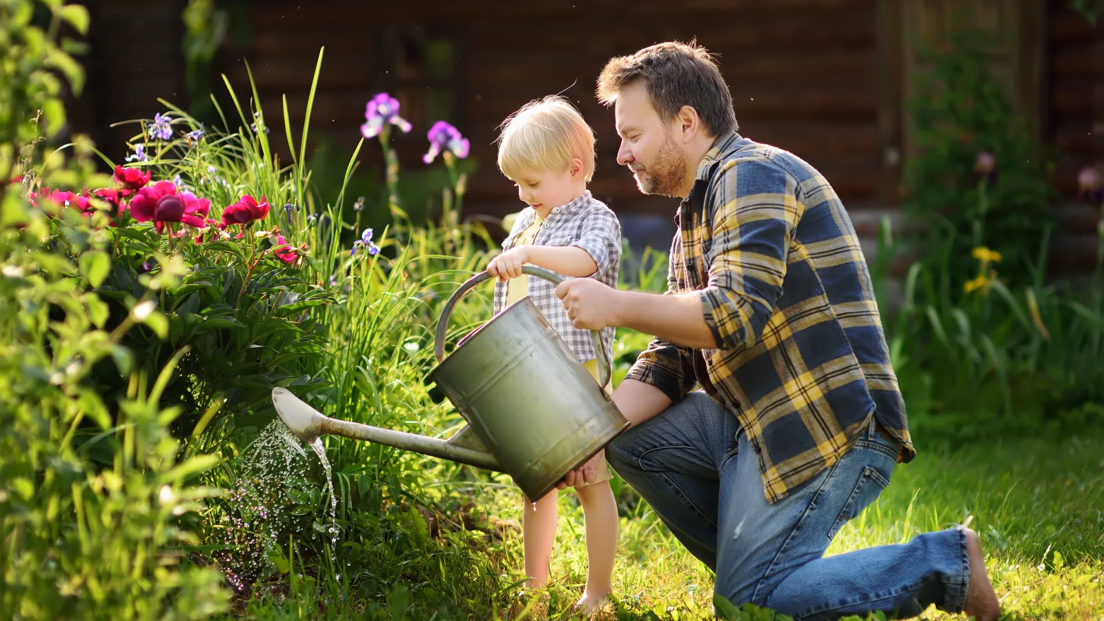 man and child watering garden