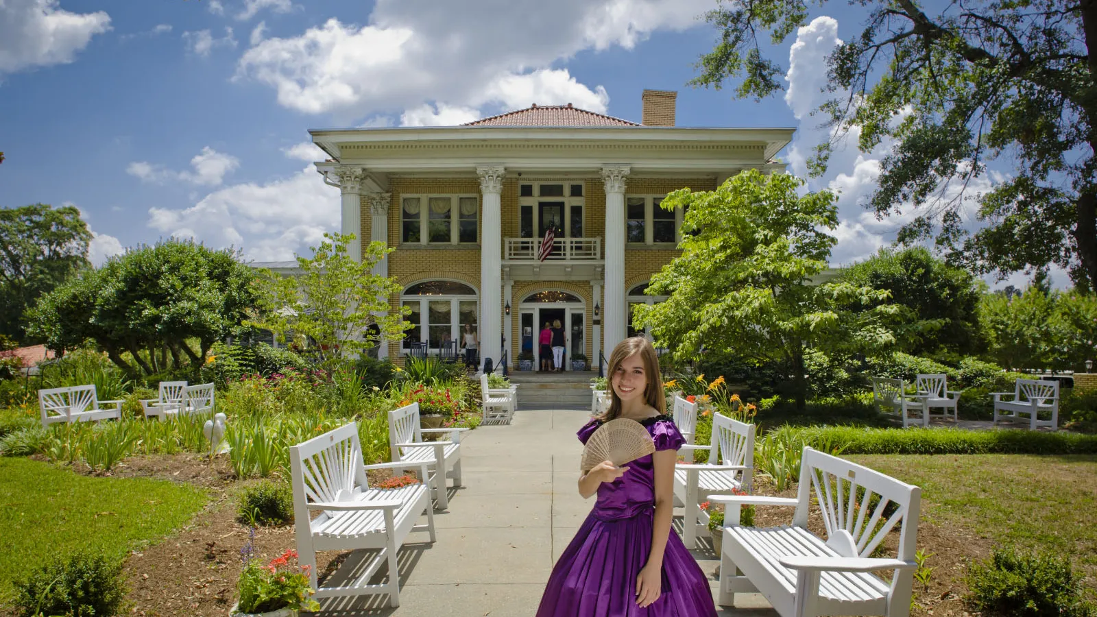 girl in front of historic home