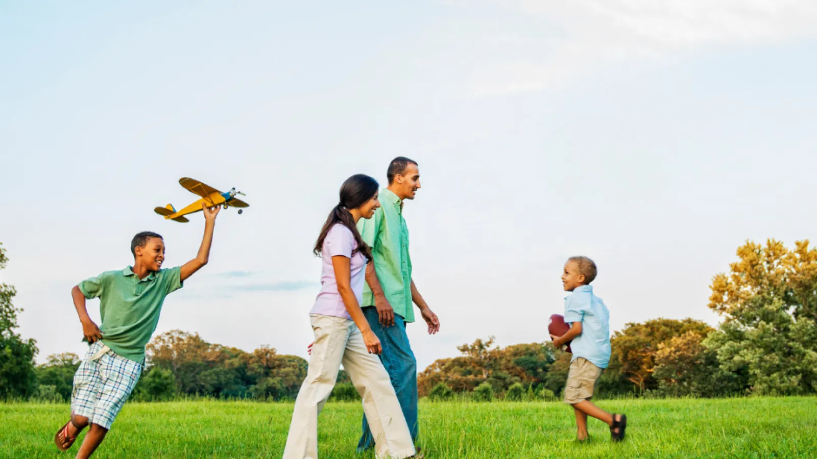 Family walking in grass