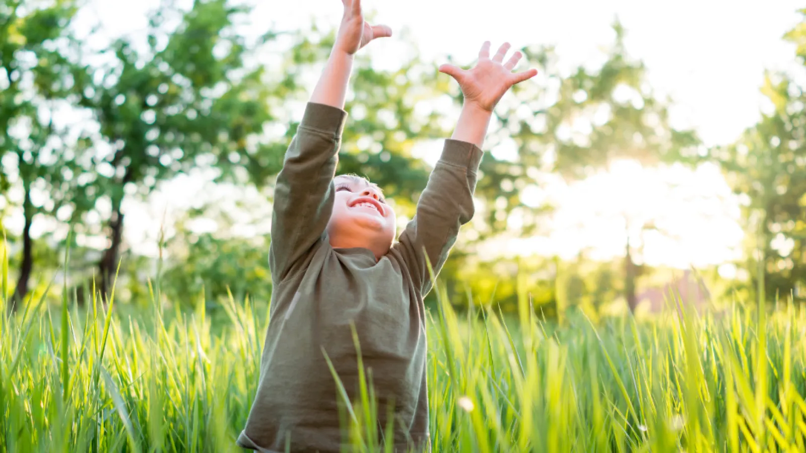 boy playing in grass