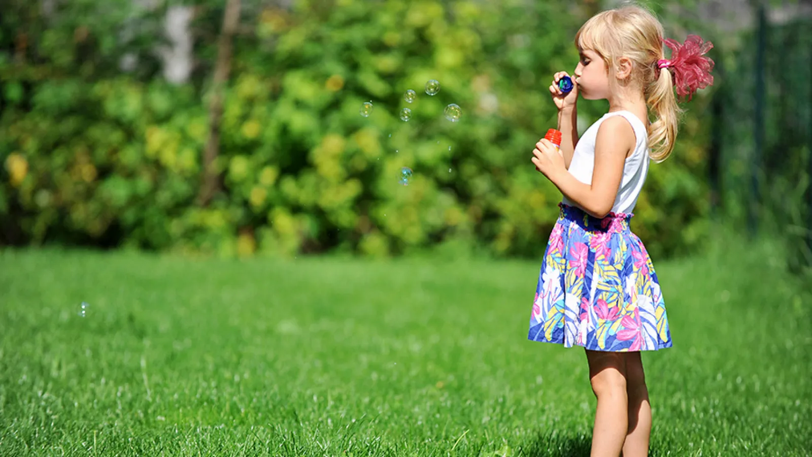 girl playing with bubbles