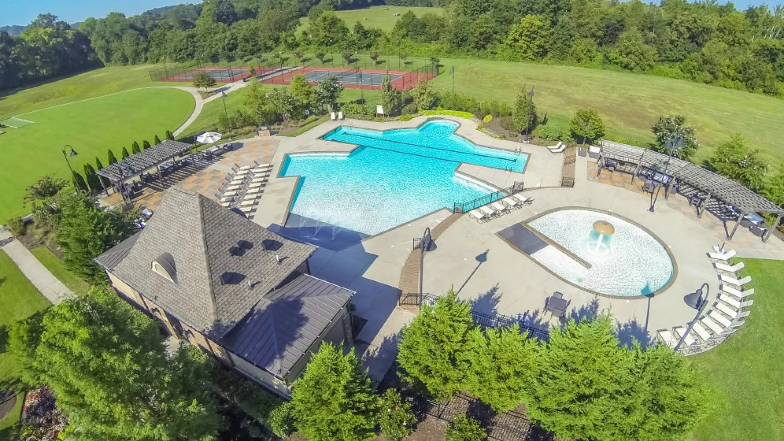 aerial image of building with land and a pool