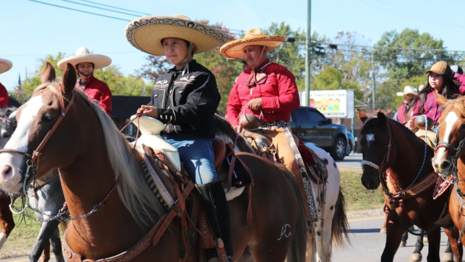 Cowboys and cowgirls riding horseback