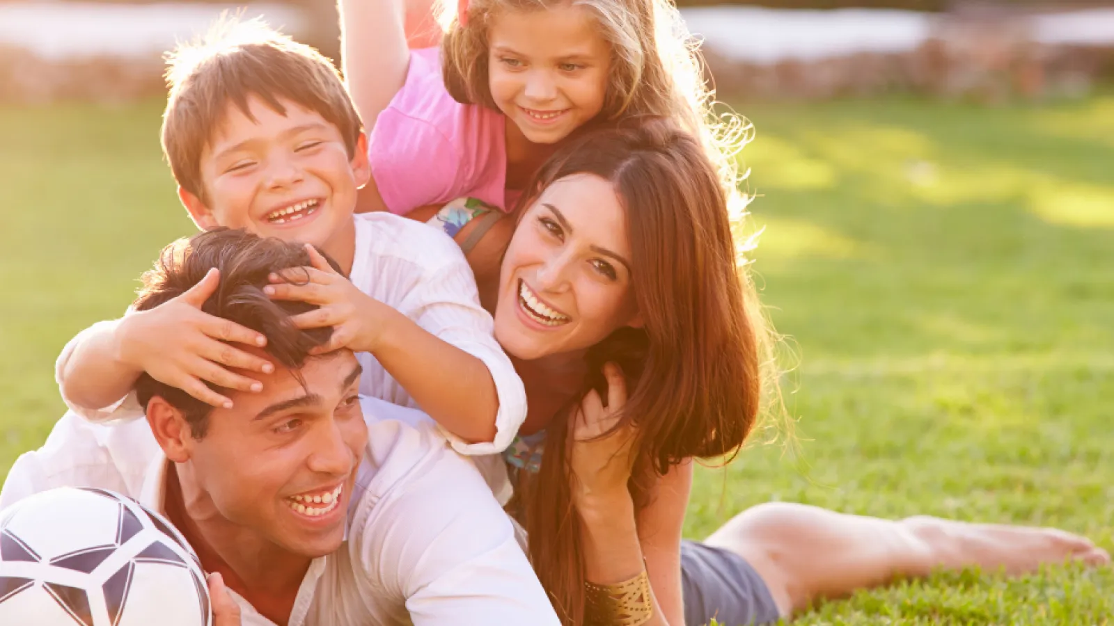 family laying in yard