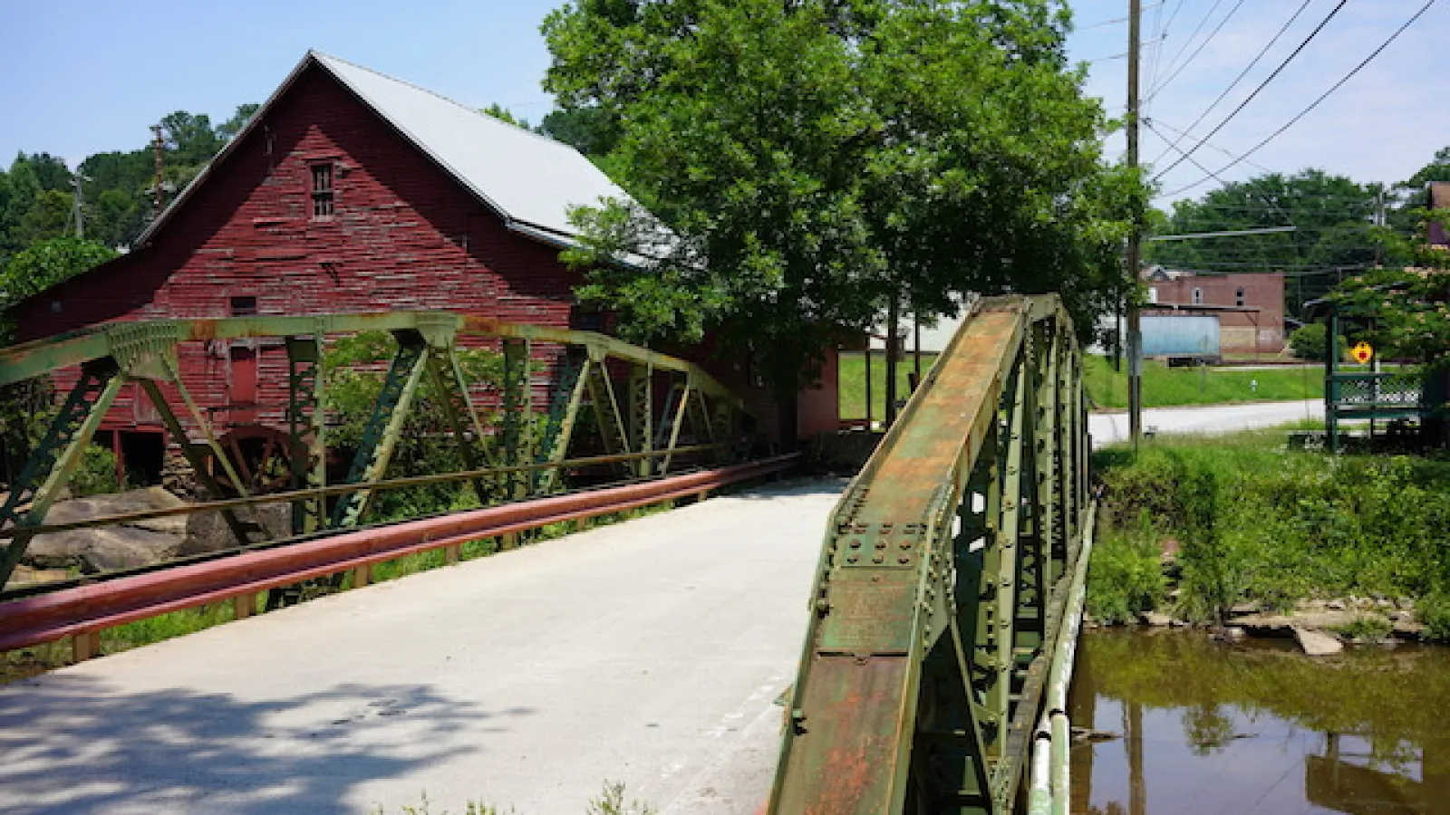 old bridge with red building