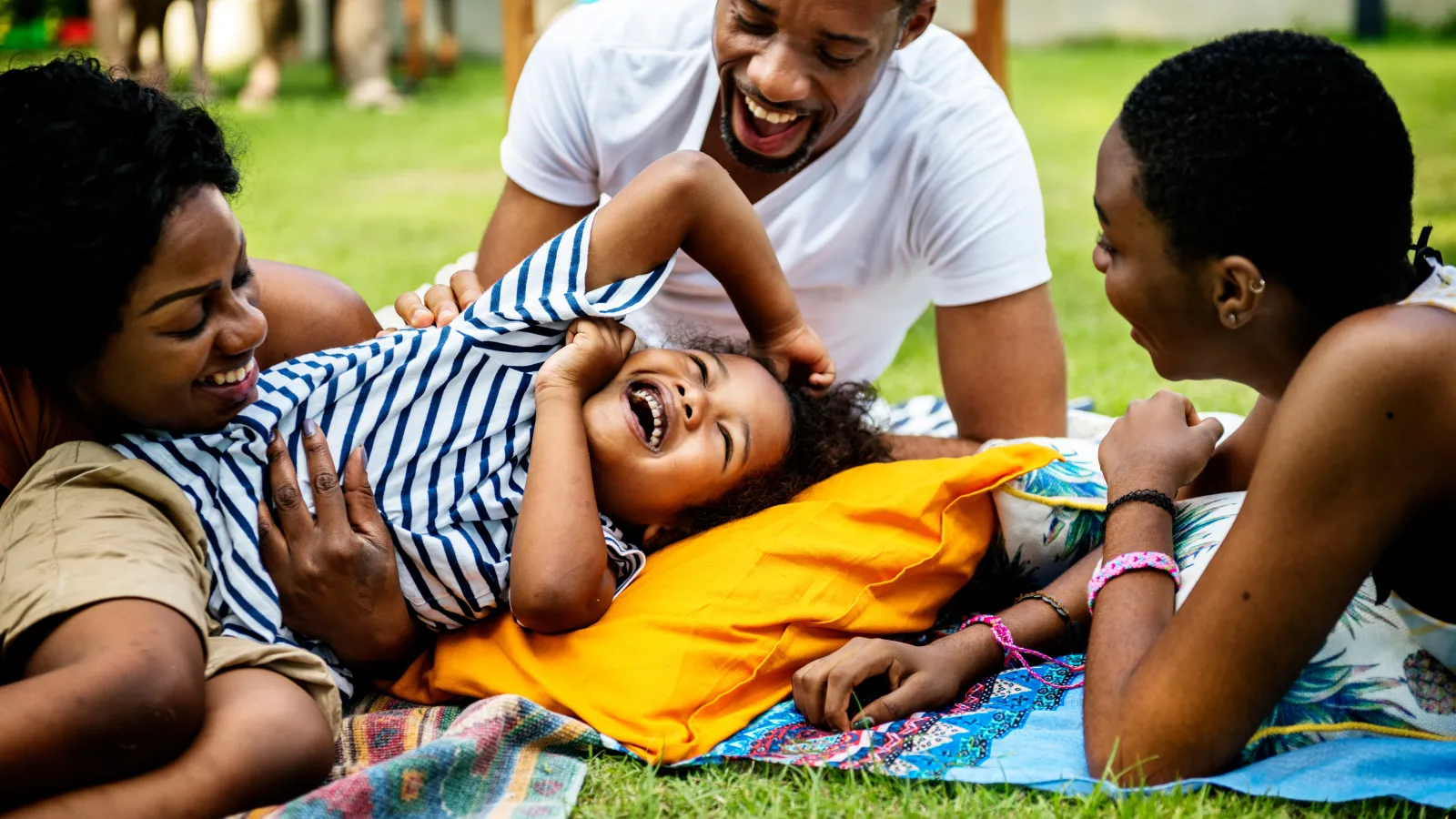 family on blanket in grass