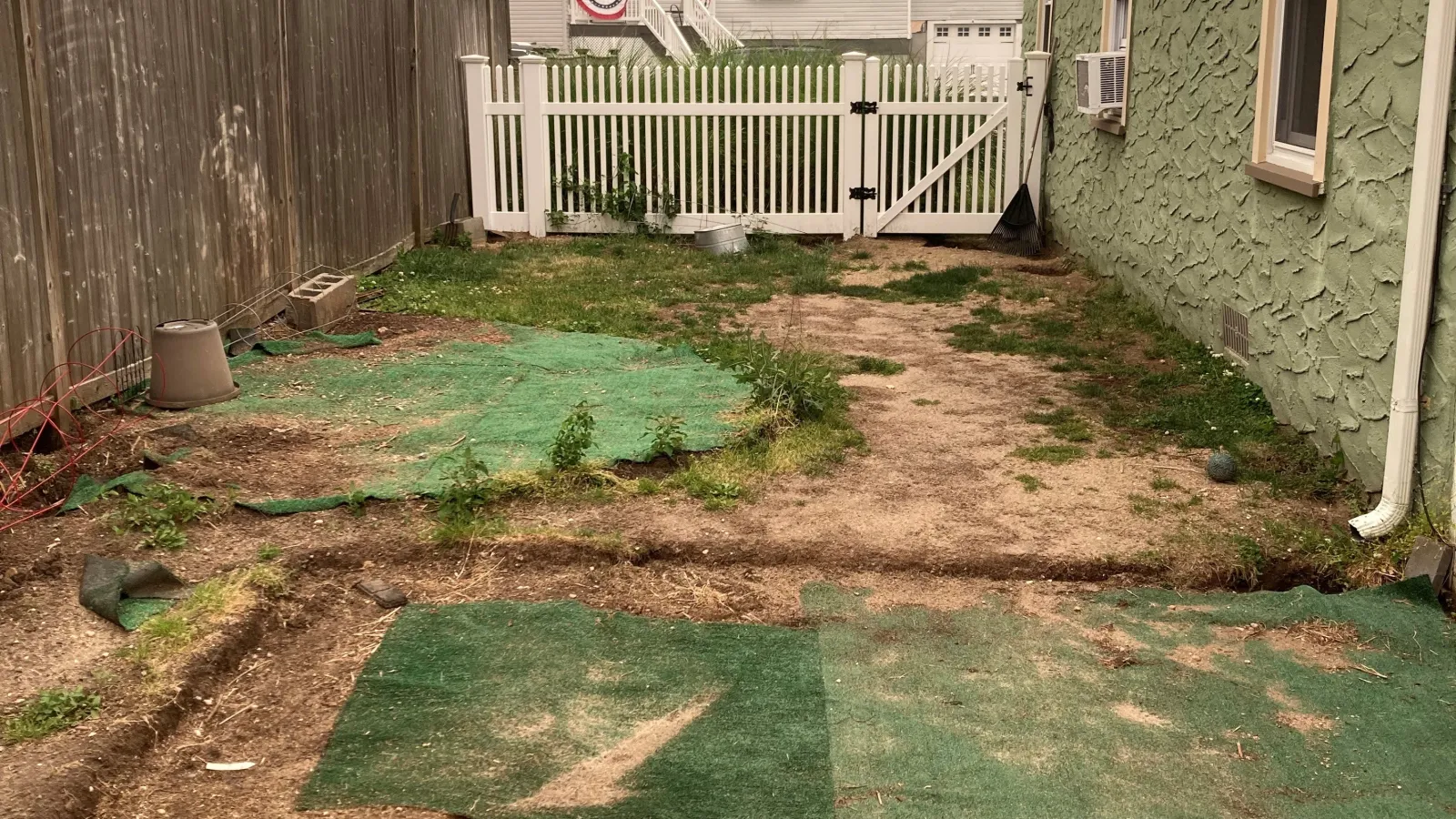 a backyard with a fence and a yard