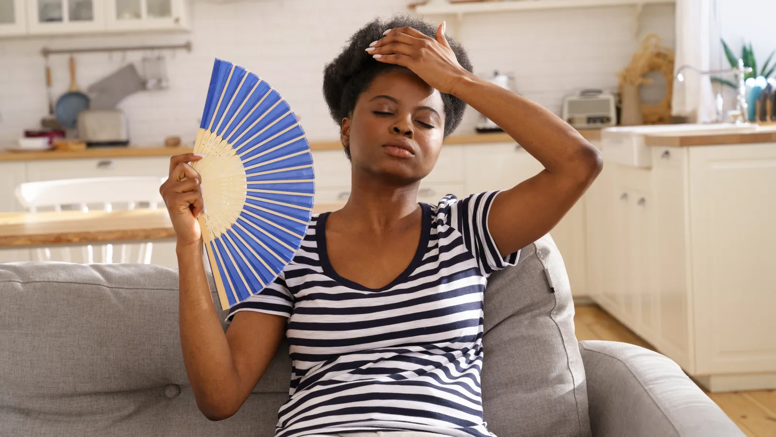 a woman holding a fan in her hand