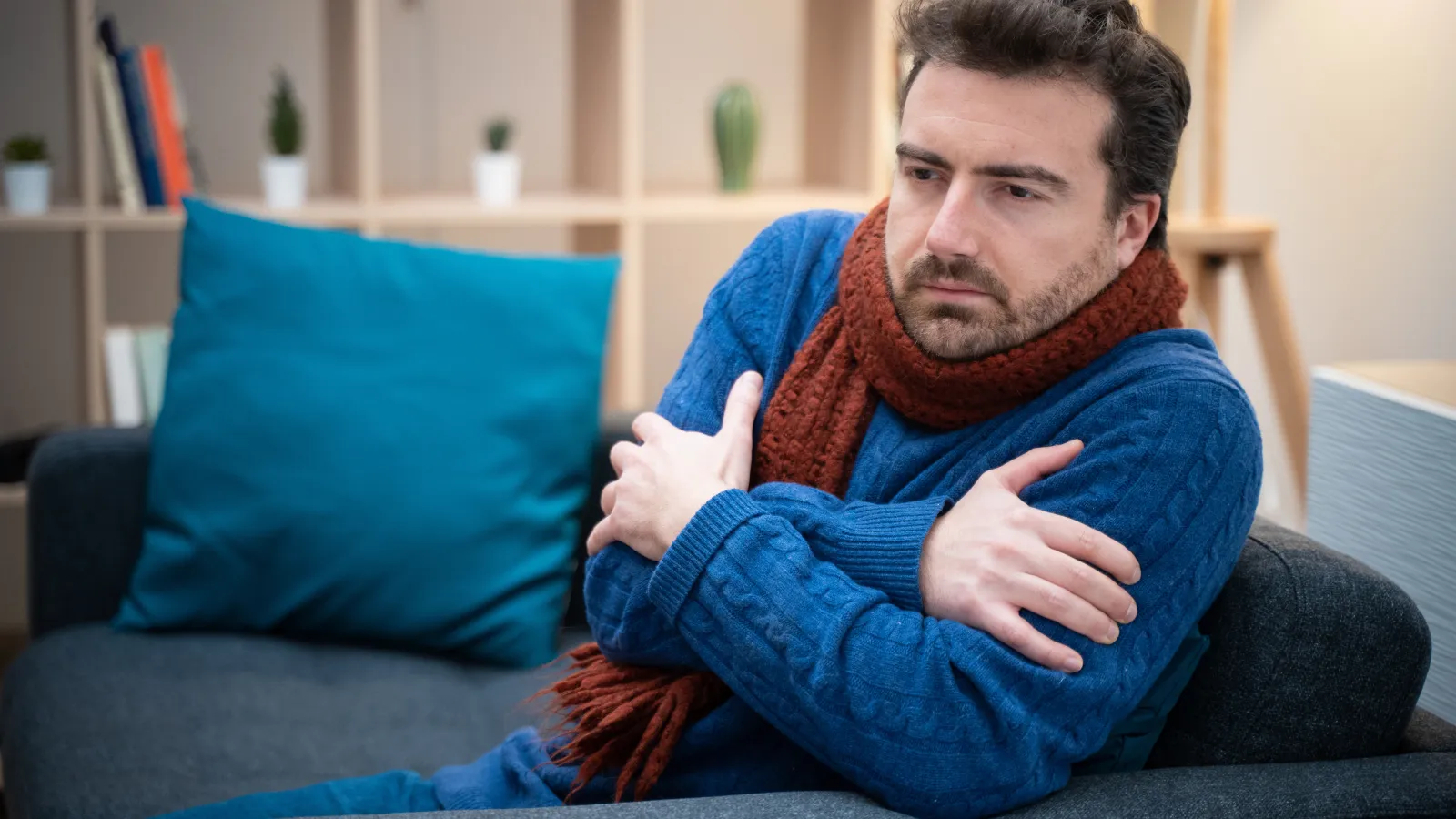 a man freezing sitting on a couch