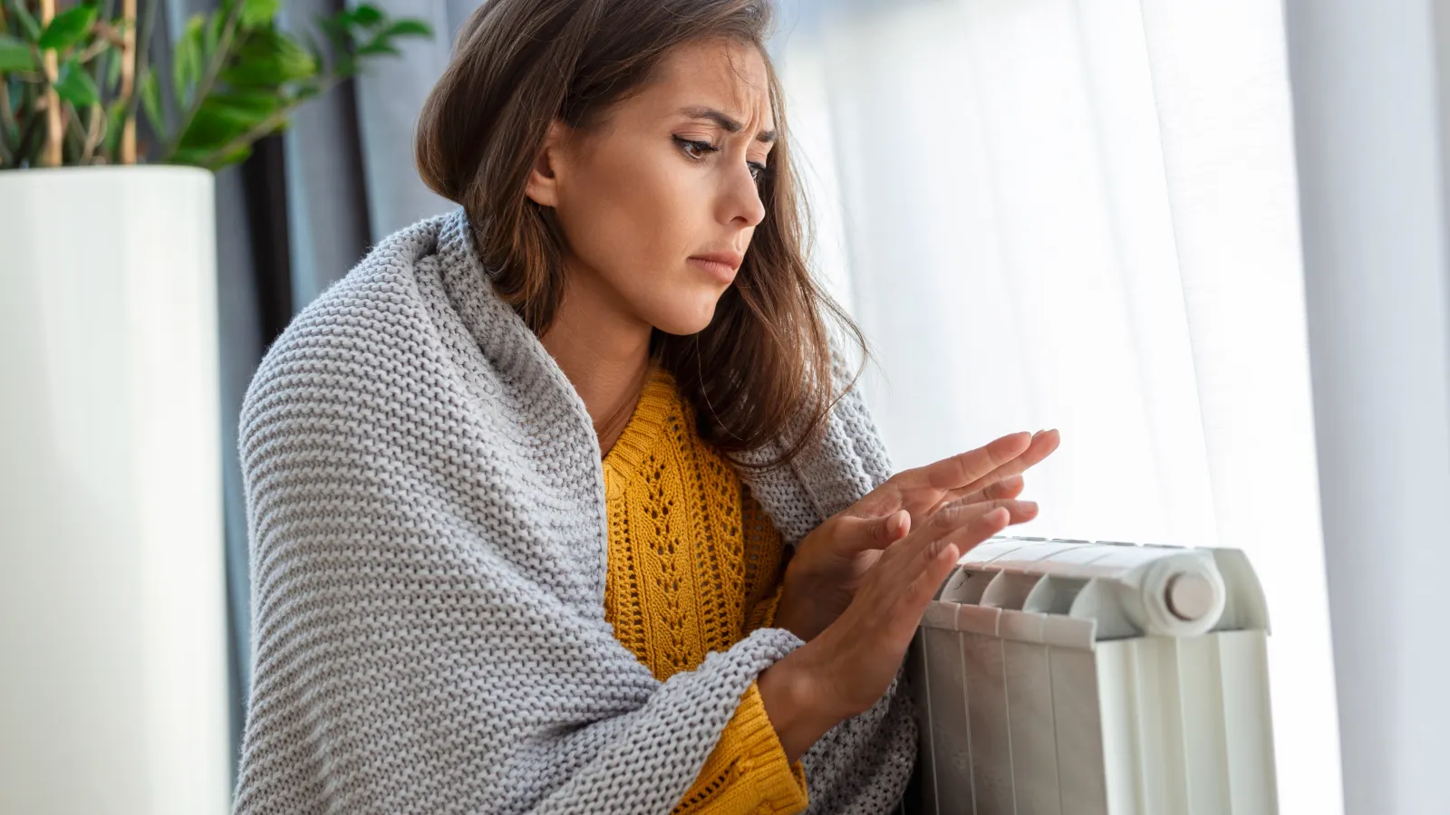 a woman next to a heating unit