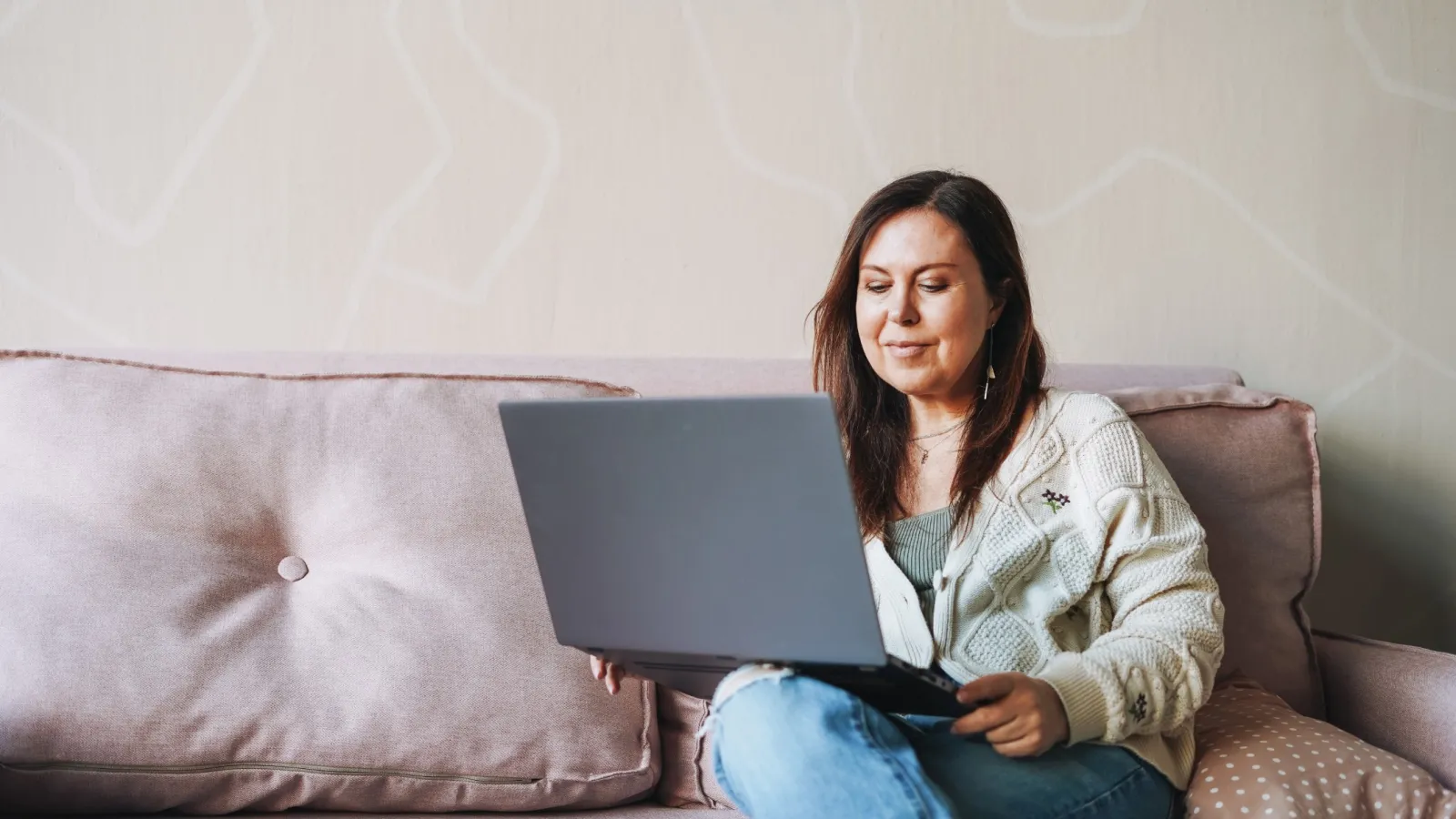 a woman sitting on a couch with a laptop