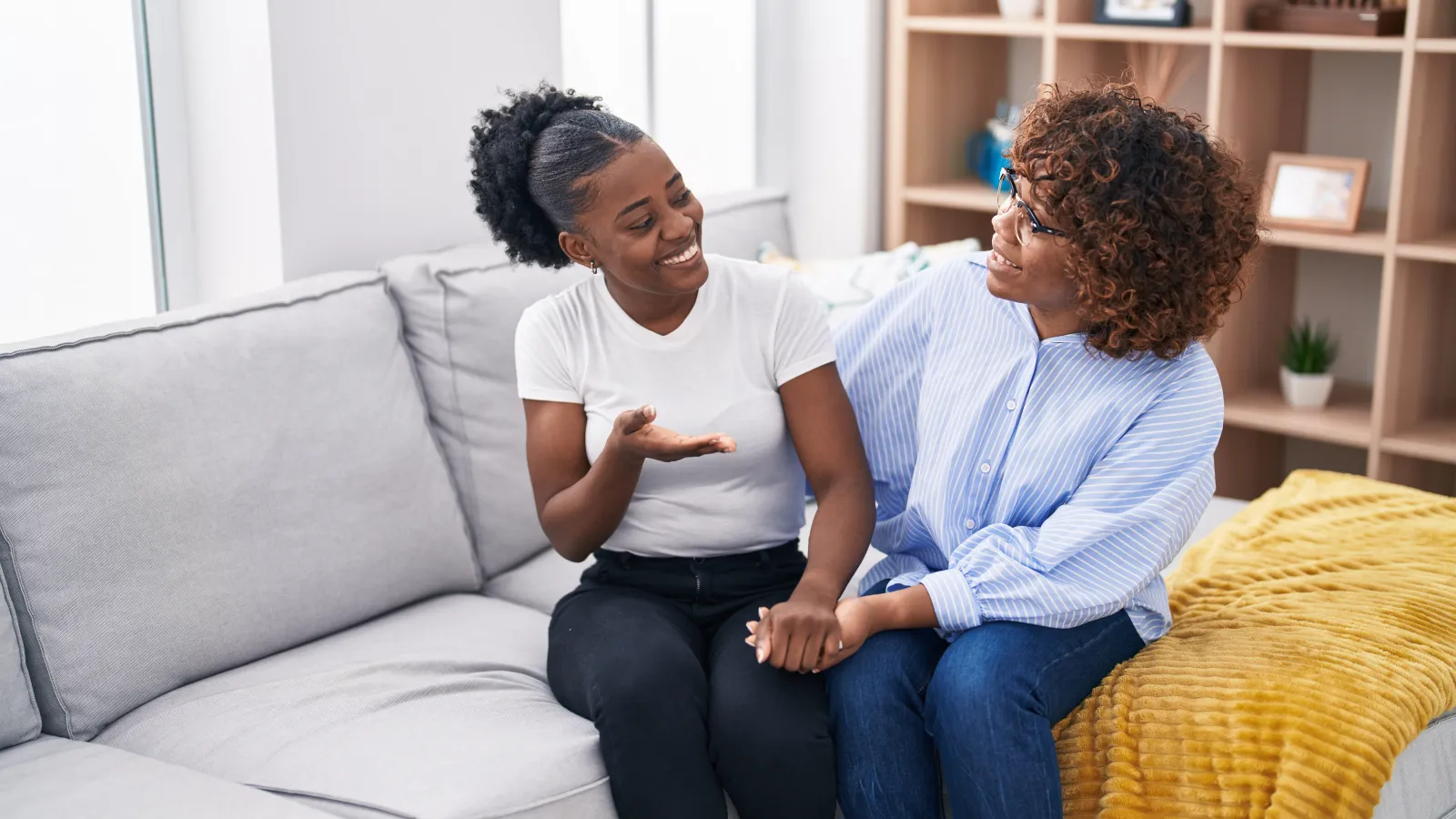 two women sitting on a couch