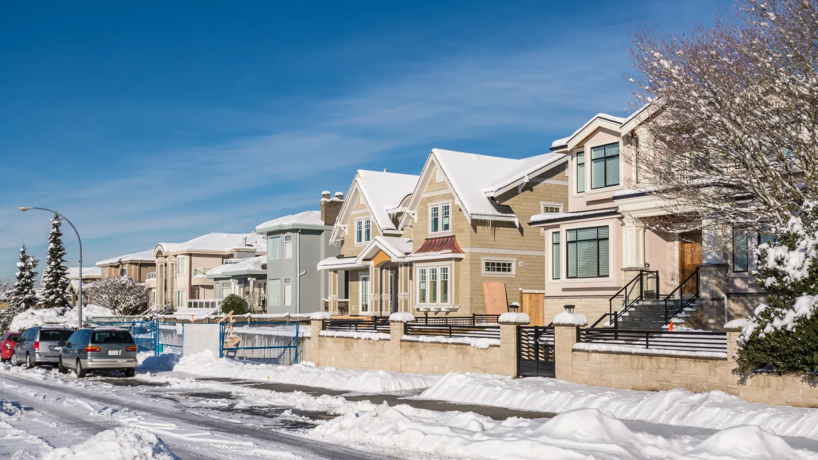 a row of houses in the snow