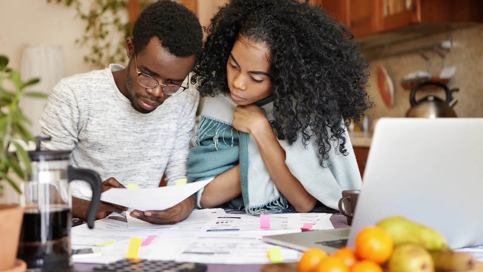 a couple looking at a paper