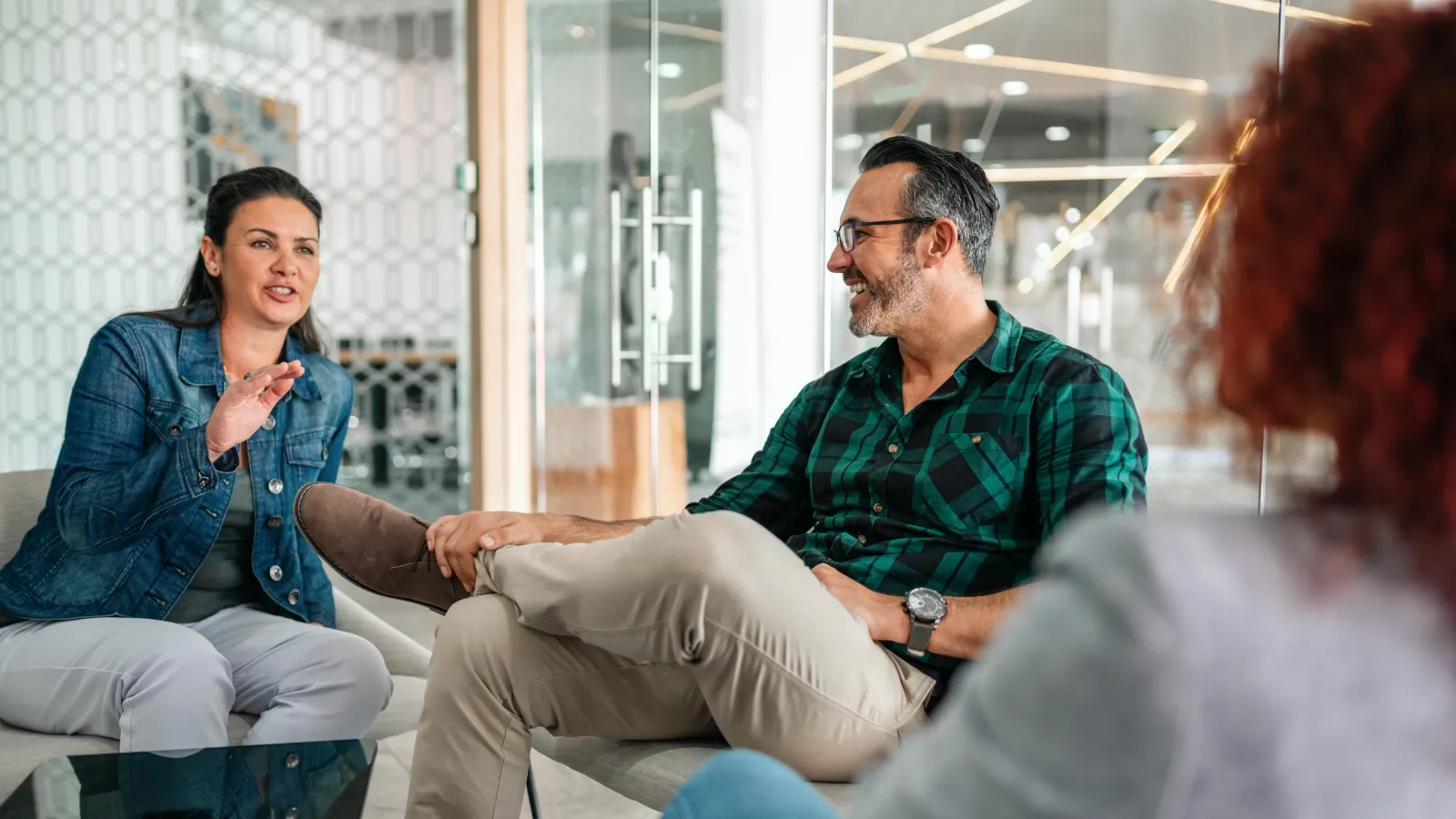 a man and a woman sitting in a meeting room