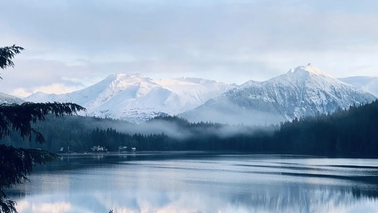 a lake with snowy mountains in the background