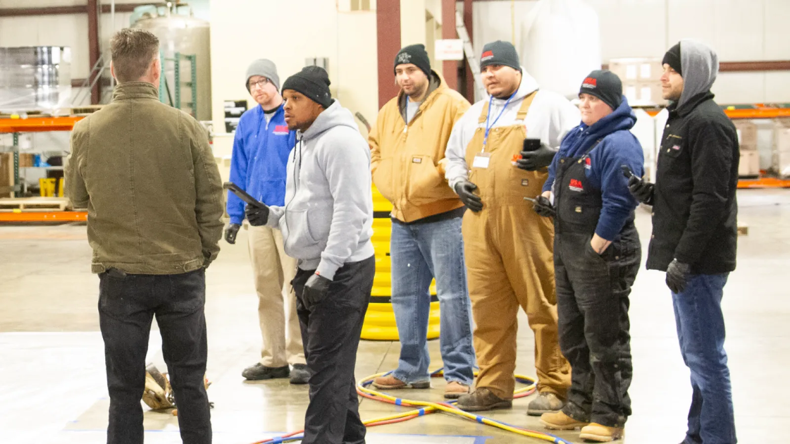 a group of people standing inside the training facility