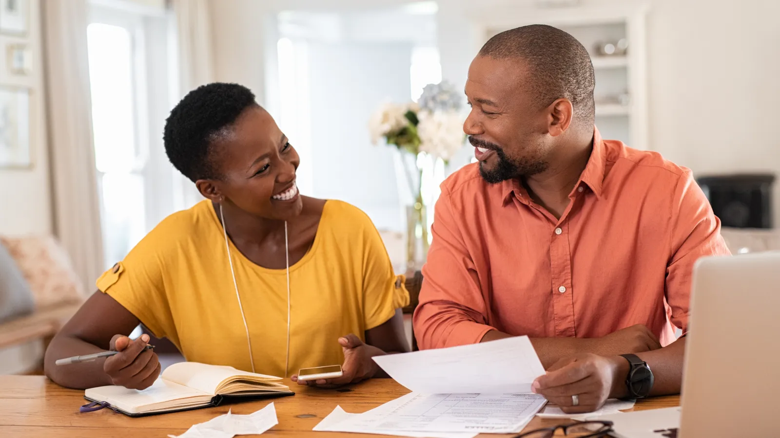 a man and a woman going over utility bills for savings